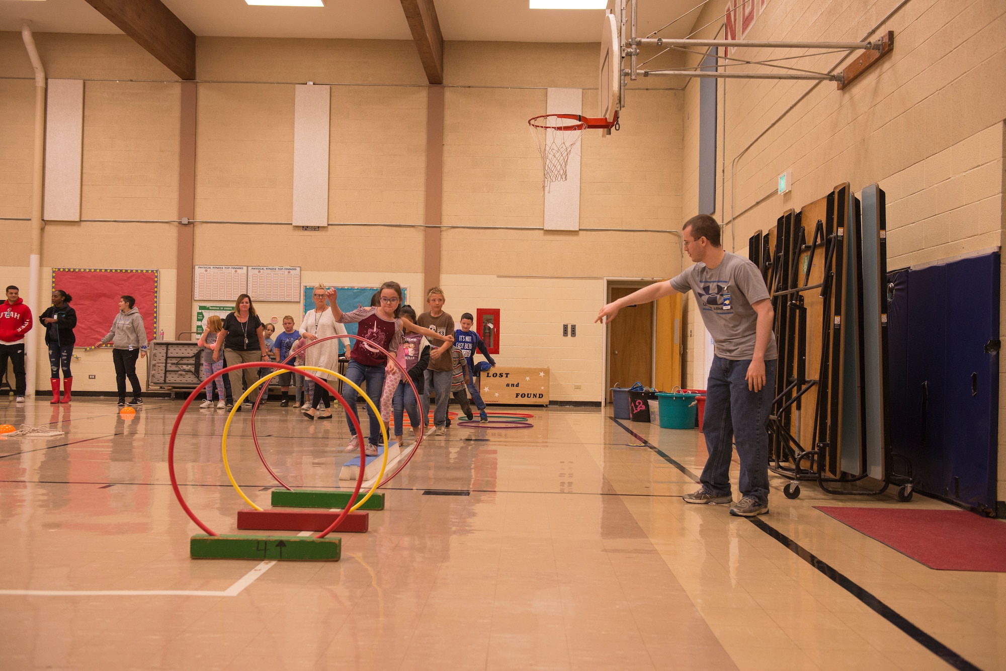 Airmen from the 366th Fighter Wing help students complete an obstacle course at North Elementary School, in Mountain Home, Idaho, October 4, 2018. North Elementary hosted their annual "Move-A-Thon" as a fundraiser for the students to go on field trips. (U.S. Air Force photo by Senior Airman Tyrell Hall)