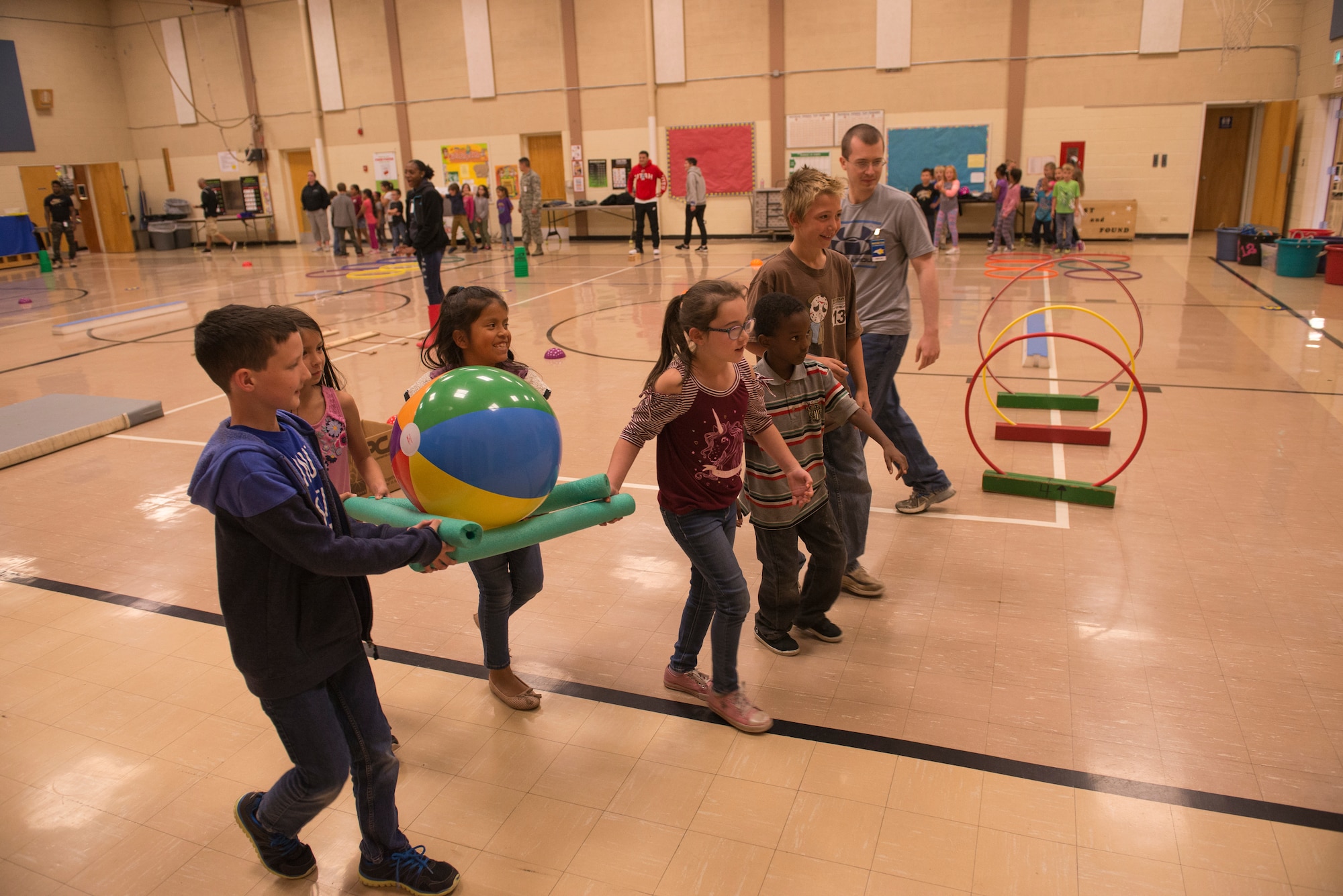 Airmen from the 366th Fighter Wing help students complete an obstacle course at North Elementary School, in Mountain Home, Idaho, October 4, 2018. North Elementary hosted their annual "Move-A-Thon" as a fundraiser for the students to go on field trips. (U.S. Air Force photo by Senior Airman Tyrell Hall)