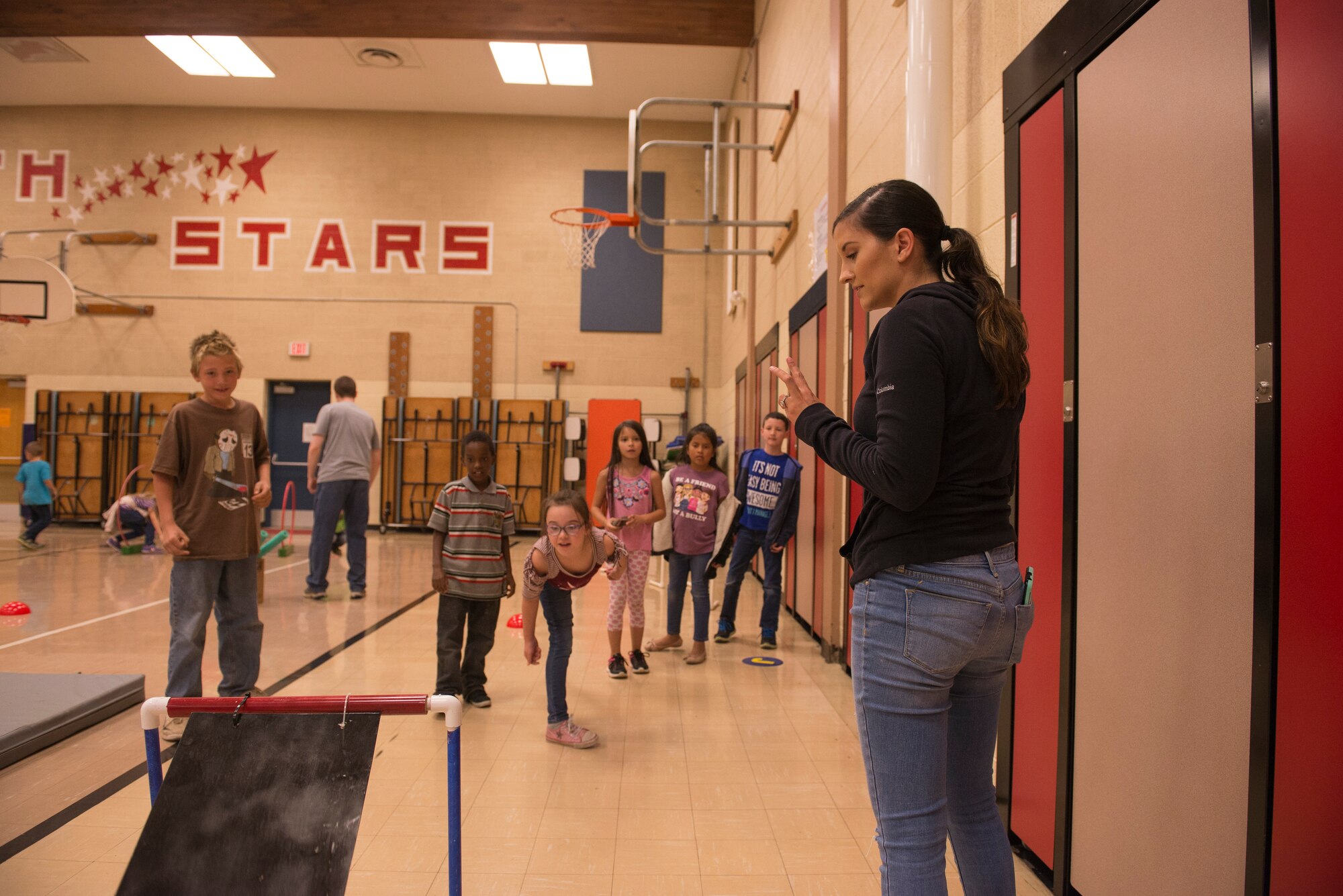 Airmen from the 366th Fighter Wing help students complete an obstacle course at North Elementary School, in Mountain Home, Idaho, October 4, 2018. North Elementary hosted their annual "Move-A-Thon" as a fundraiser for the students to go on field trips. (U.S. Air Force photo by Senior Airman Tyrell Hall)