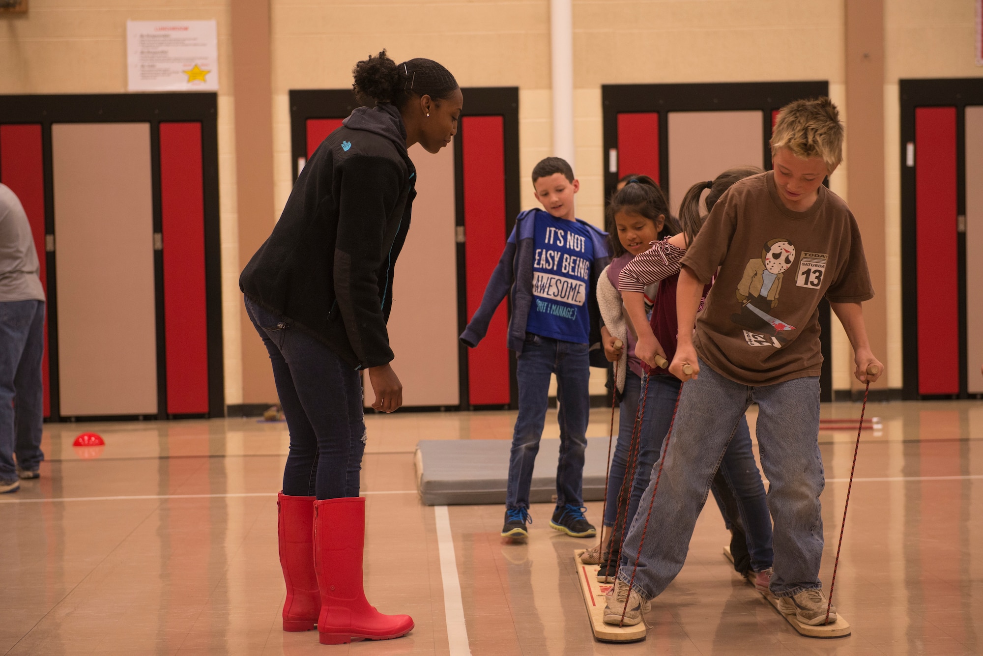 Airmen from the 366th Fighter Wing help students complete an obstacle course at North Elementary School, in Mountain Home, Idaho, October 4, 2018. North Elementary hosted their annual "Move-A-Thon" as a fundraiser for the students to go on field trips. (U.S. Air Force photo by Senior Airman Tyrell Hall)