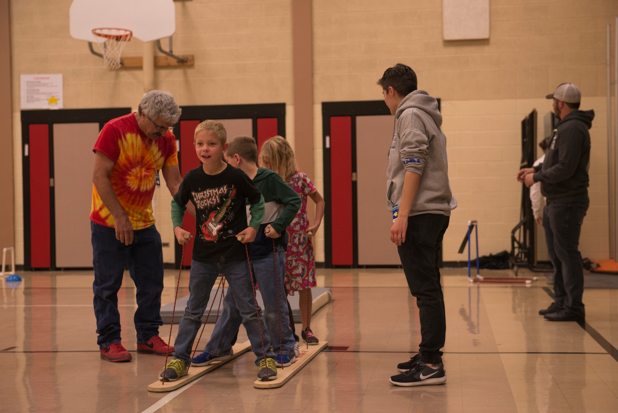 Airmen from the 366th Fighter Wing help students complete an obstacle course at North Elementary School, in Mountain Home, Idaho, October 4, 2018. North Elementary hosted their annual "Move-A-Thon" as a fundraiser for the students to go on field trips. (U.S. Air Force photo by Senior Airman Tyrell Hall)