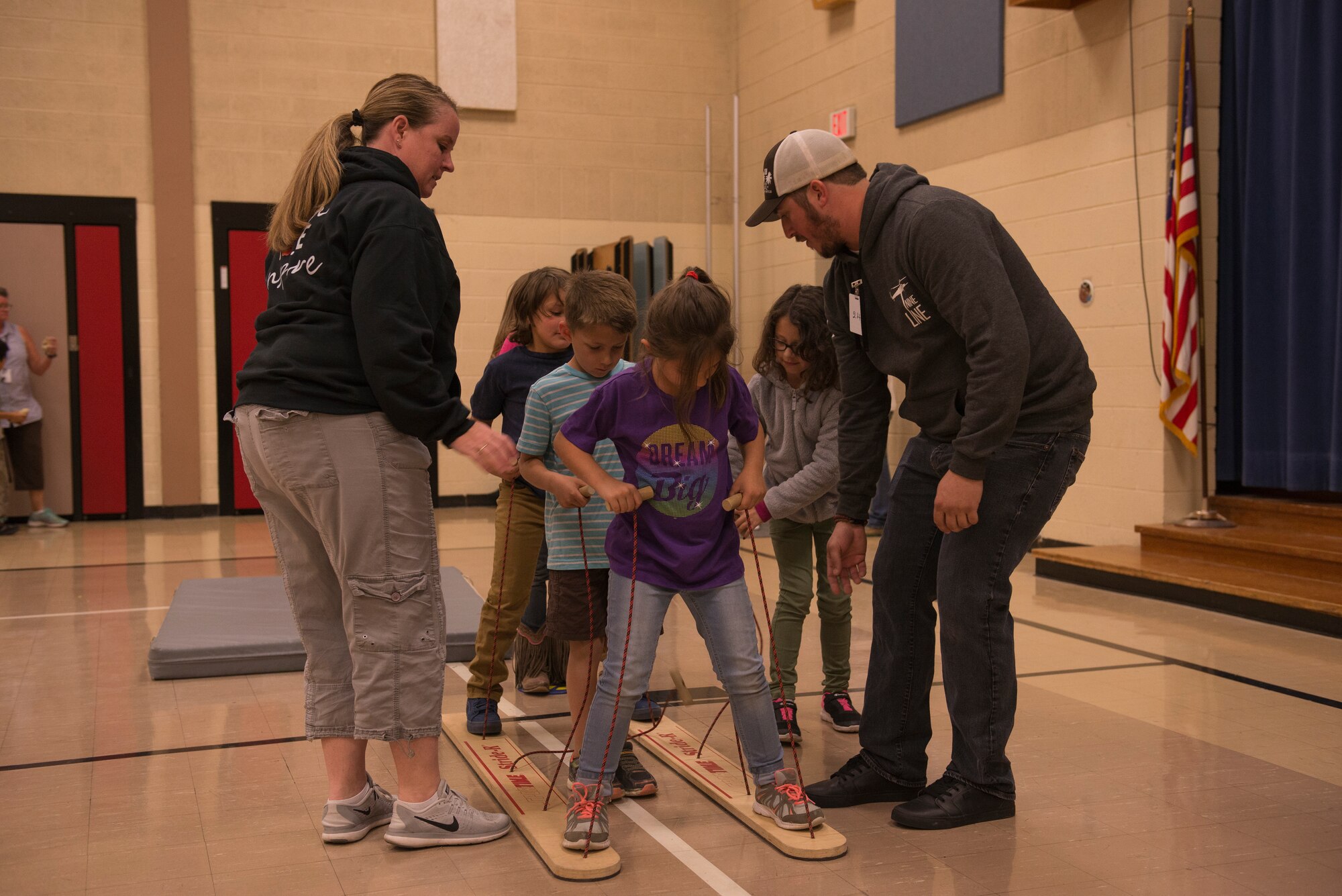 Airmen from the 366th Fighter Wing help students complete an obstacle course at North Elementary School, in Mountain Home, Idaho, October 4, 2018. North Elementary hosted their annual "Move-A-Thon" as a fundraiser for the students to go on field trips. (U.S. Air Force photo by Senior Airman Tyrell Hall)