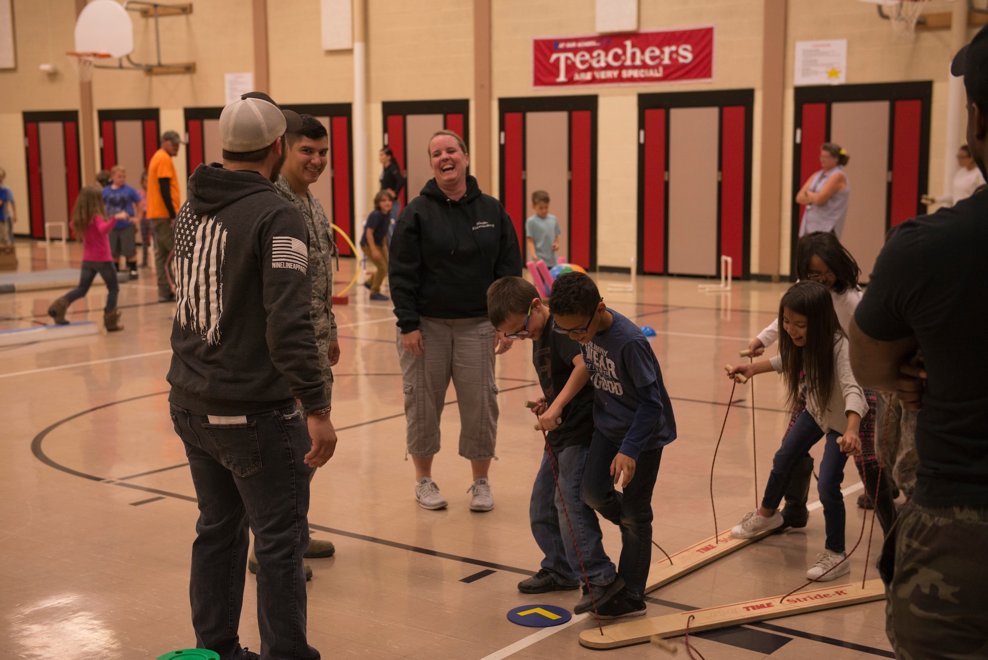 Airmen from the 366th Fighter Wing help students complete an obstacle course at North Elementary School, in Mountain Home, Idaho, October 4, 2018. North Elementary hosted their annual "Move-A-Thon" as a fundraiser for the students to go on field trips. (U.S. Air Force photo by Senior Airman Tyrell Hall)