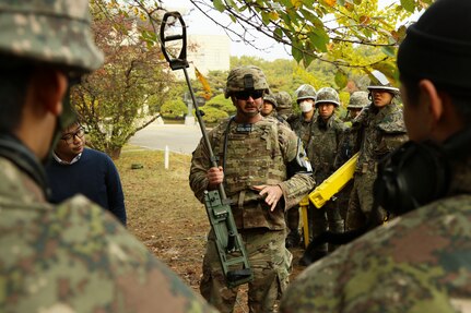 Staff Sgt. Daniel Lewis, and Explosive Ordnance Disposal Technician, assigned  to the 2nd Infantry Division, demonstrates the capabilities of a U.S. mine detector to ROK engineers during a training session prior to engaging in a mine clearing operation at the Joint Security Area near Panmunjon, South Korea, Oct. 16.