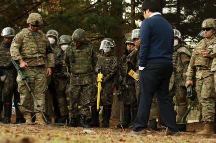 Staff Sgt. Daniel Lewis, and Explosive Ordnance Disposal Technician, assigned to the 2nd Infantry Division, demonstrates proper sweeping and isolating techniques using a mine detector to ROK engineers during a training session prior to engaging in a mine clearing operation at the Joint Security Area near Panmunjon, South Korea, Oct. 16.