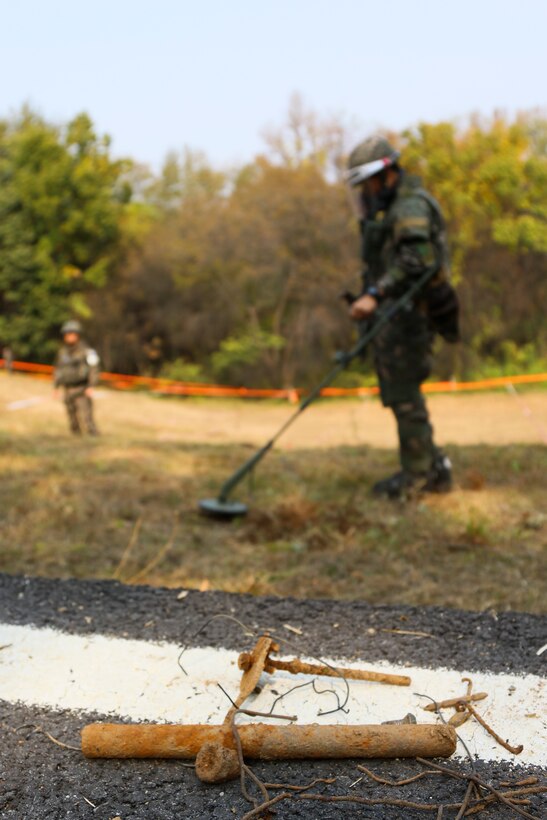 Pieces of metal debris uncovered by ROK engineers sit in the foreground during  a mine clearing operation at the Joint Security Area near Panmunjon, South  Korea, Oct. 16