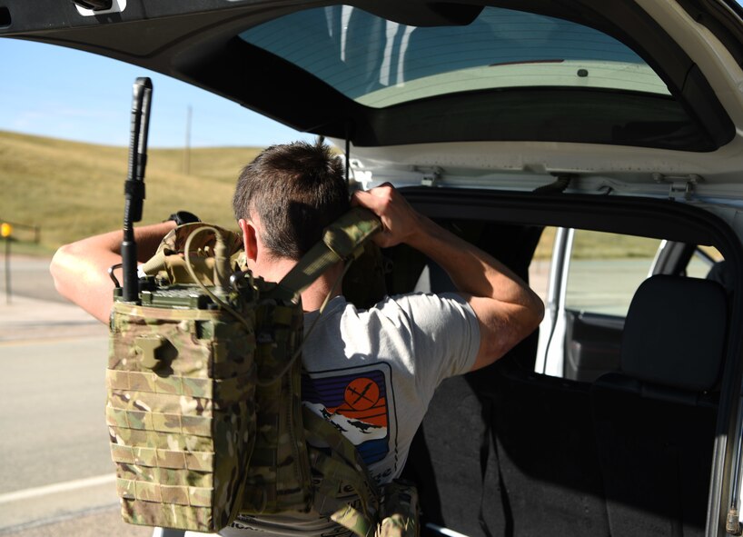 Senior Airman Steven, a 5th Air Support Operations Squadron joint terminal attack controller, dons his vest and radio in Belle Fourche, S.D., Oct. 17, 2018. JTACs from Joint Base Lewis-McChord, Wash., participated in Combat Raider 19-1, an exercise hosted by the 28th Bomb Wing, to train with bombers from all 8th Air Force bases. (U.S. Air Force photo by Airman 1st Class Thomas Karol)