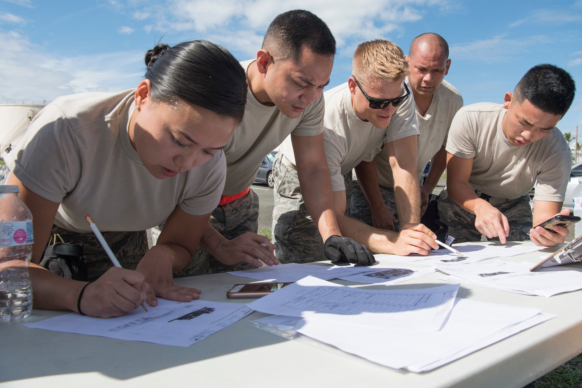 U.S. Air Force Staff Sergeant Hui Jin Kim, Senior Airman Brian Garlejo, Staff Sgt. Nathaniel Petraitis, Tech. Sgt. Isaiah Laikupu and Senior Airman Kouyo Kato, members of the Air Force Reserve’s 48th Aerial Port Squadron, calculate the proper way to balance the cargo given in the training scenario Oct. 13, 2018, at Joint Base Pearl Harbor-Hickam, Hawaii. The 48th APS, which is part of the 624th Regional Support Group, deploys qualified personnel to provide air terminal operations worldwide in support of contingency operations, exercises, unit moves, and foreign humanitarian relief or disaster operations. (U.S. Air Force photo by Master Sgt. Theanne Herrmann)