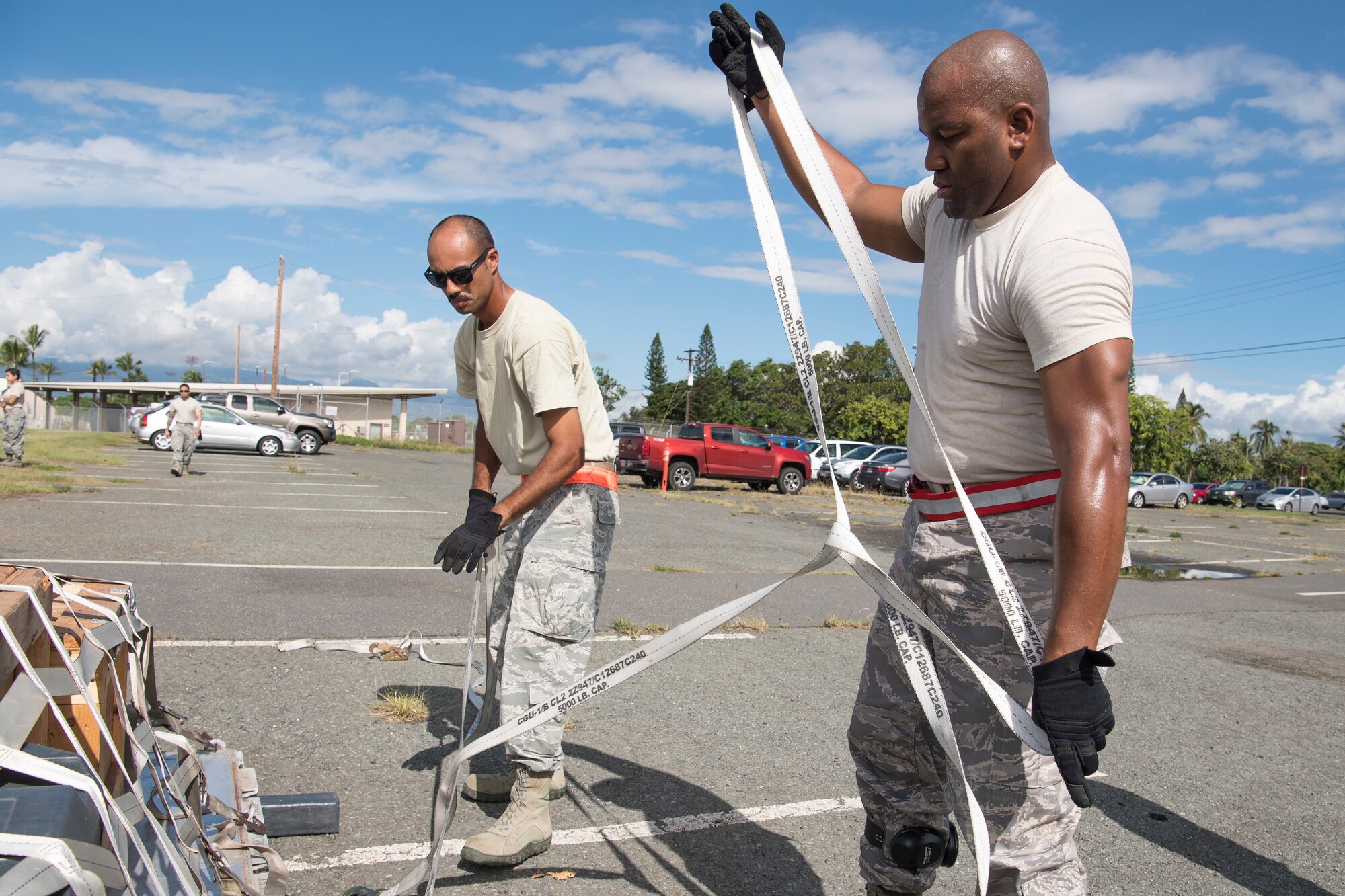 U.S. Air Force Tech. Sgt. Shane Costa and Staff Sgt. Osiris Terry, members of the Air Force Reserve’s 48th Aerial Port Squadron, strap down equipment during a pallet building training exercise designed to perfect their skills as air transportation specialists Oct. 13, 2018, at Joint Base Pearl Harbor-Hickam, Hawaii. The 48th APS, which is part of the 624th Regional Support Group, deploys qualified personnel to provide air terminal operations worldwide in support of contingency operations, exercises, unit moves, and foreign humanitarian relief or disaster operations. (U.S. Air Force photo by Master Sgt. Theanne Herrmann)