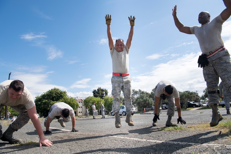 U.S. Air Force Tech. Sgt. Joseph Patricio, center, a member of the Air Force Reserve’s 48th Aerial Port Squadron, does a burpee exercise along with his teammates Oct. 13, 2018, during a training exercise at Joint Base Pearl Harbor-Hickam, Hawaii. The 48th APS, which is part of the 624th Regional Support Group, deploys qualified personnel to provide air terminal operations worldwide in support of contingency operations, exercises, unit moves, and foreign humanitarian relief or disaster operations. (U.S. Air Force photo by Master Sgt. Theanne Herrmann)