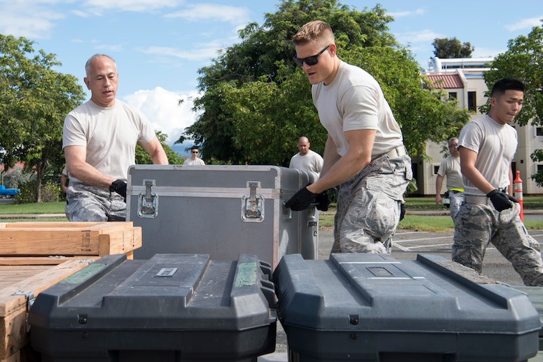 U.S. Air Force Master Sgt. Ricky Graham and Staff Sgt. Nathaniel Petraitis, members of the Air Force Reserve’s 48th Aerial Port Squadron, move equipment during a pallet building training exercise designed to perfect their skills as air transportation specialists Oct. 13, 2018, at Joint Base Pearl Harbor-Hickam, Hawaii. The 48th APS, which is part of the 624th Regional Support Group, deploys qualified personnel to provide air terminal operations worldwide in support of contingency operations, exercises, unit moves, and foreign humanitarian relief or disaster operations. (U.S. Air Force photo by Master Sgt. Theanne Herrmann)