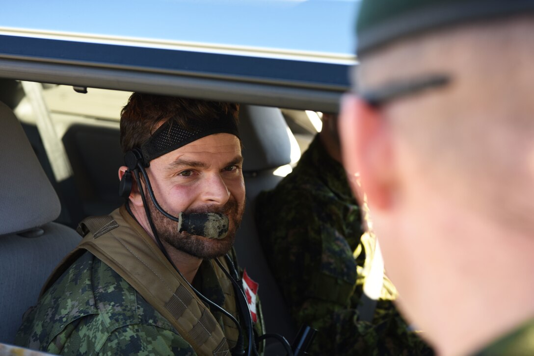 Capt. Chris Tymchuk, a joint tactical air controller troop commander assigned to the Royal Canadian Horse Artillery, 1st Regiment, works with another JTAC in Belle Fourche, S.D., Oct. 17, 2018. JTACs from the 1st RCHA assisted in Combat Raider 19-1, which helped them become familiar with the B-1 and its capabilities. (U.S. Air Force photo by Airman 1st Class Thomas Karol)