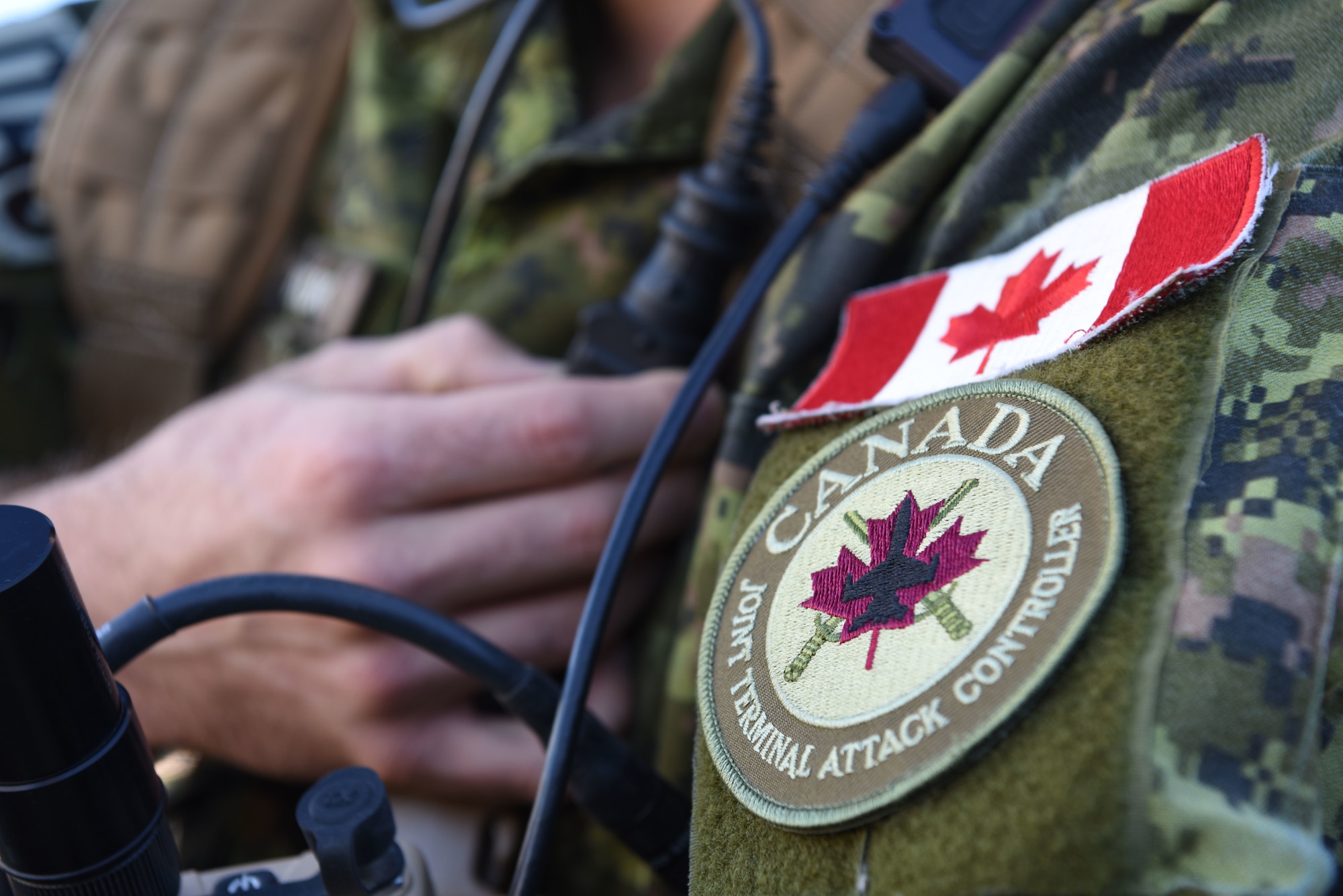 Capt. Chris Tymchuk calls in a simulated airstrike on Oct. 17, 2018, during Combat Raider 19-1, an exercise hosted by the 28th Bomb Wing at the Powder River Training Complex, S.D. Tymchuk is a joint tactical air controller troop commander assigned to the Royal Canadian Horse Artillery, 1st Regiment. JTACs from the 1st RCHA assisted in Combat Raider 19-1, that helped them become familiar with the B-1 and its capabilities. (U.S. Air Force photo by Airman 1st Class Thomas Karol)