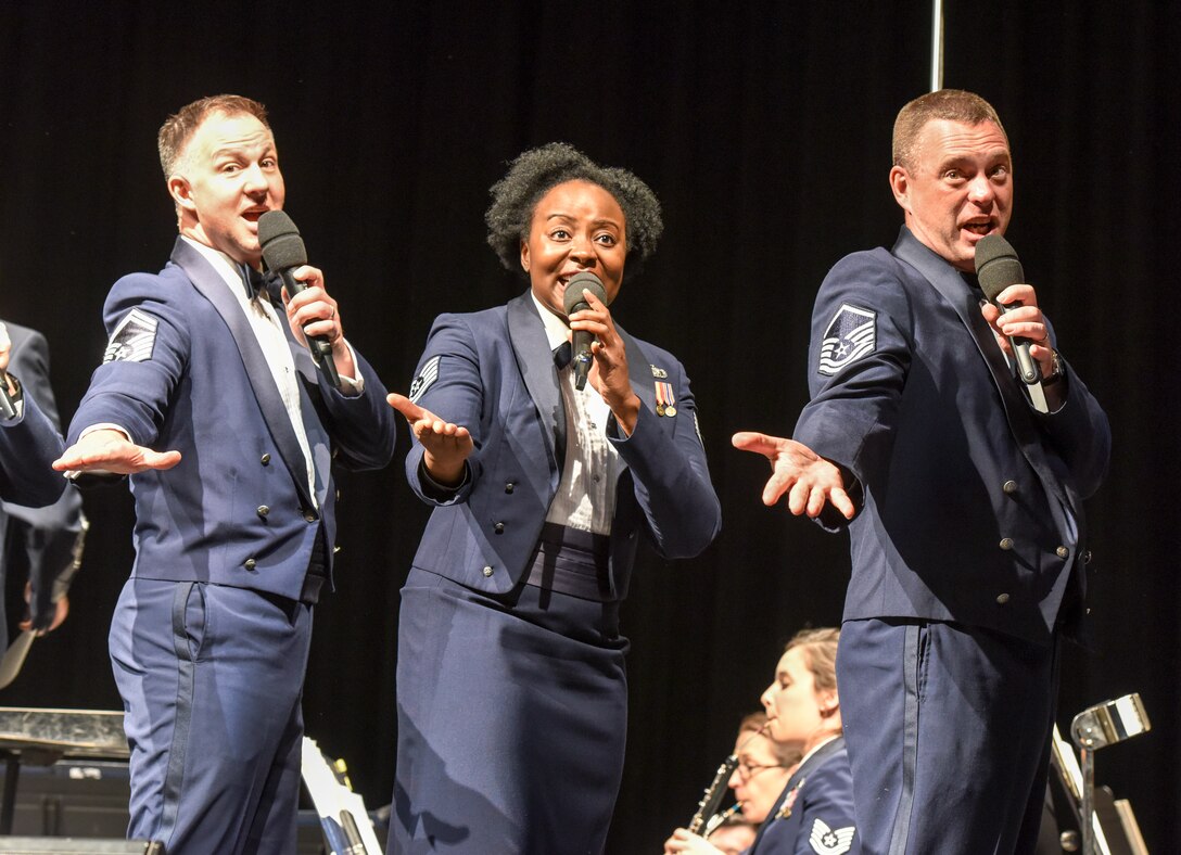 U.S. Air Force Senior Master Sgt. Brad Bennett, Tech. Sgt. Stacie Holliday, and Master Sgt. Eric Sullivan, Singing Sergeants members, perform with the Air Force Concert Band at the Murphey Performance Hall in San Angelo, Texas, Oct. 22, 2018. The Singing Sergeants feature 23 active-duty Airmen and present more than 200 performances annually. (U.S. Air Force photo by Aryn Lockhart/Released)