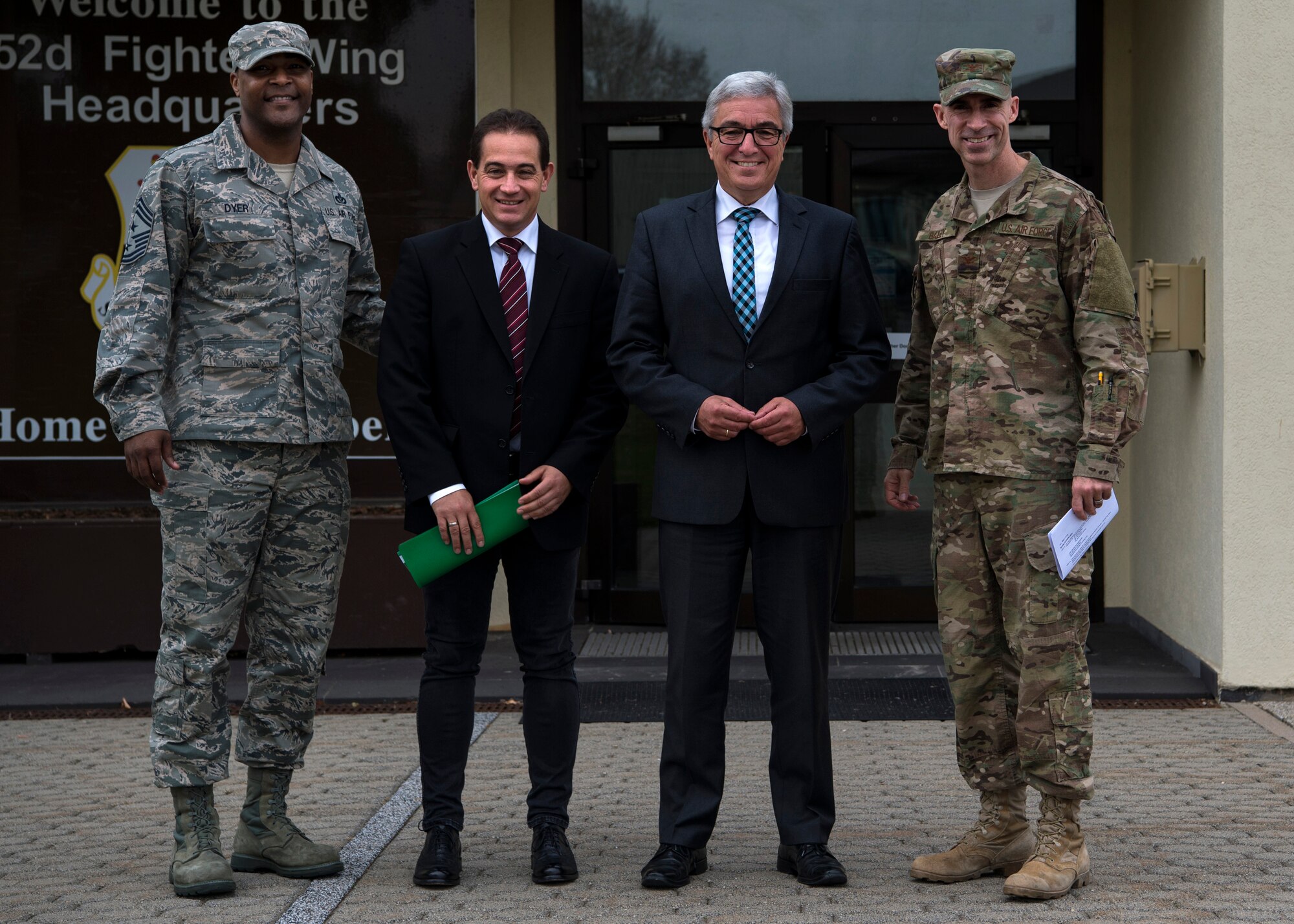 U.S. Air Force Col. Jason Bailey, 52nd Fighter Wing commander, right, and Chief Master Sgt. Alvin Dyer, 52nd FW command chief, left, welcome Roger Lewentz, Minister of the Interior of Rhineland-Palatinate, Germany, center right, and Dr. Hannes Kopf, Ministerial Director of the Ministry of the Interior, center left, to Spangdahlem Air Base, Germany, Oct. 22, 2018. The visit gave Lewentz and Kopf an opportunity to learn about base functions. (U.S. Air Force photo by Airman 1st Class Valerie Seelye)