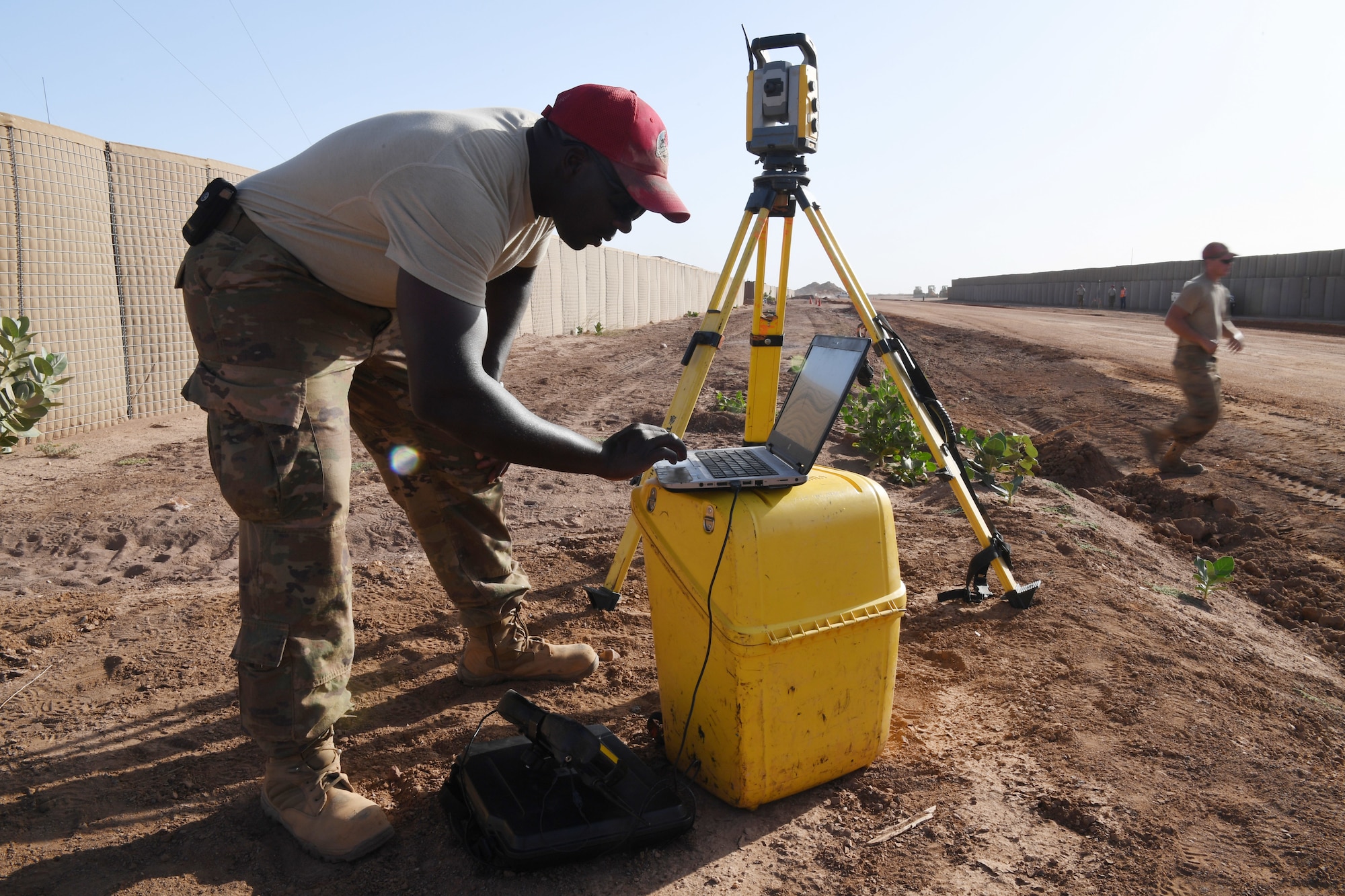 U.S. Air Force Tech. Sgt. Cameron Steele, 31st Expeditionary Rapid Engineer Deployable Heavy Operation Repair Squadron Engineer electrician, evaluates the elevation for a modified test strip at Nigerien Air Base 201, Agadez, Niger, Oct. 19, 2018. An evaluation is done to ensure proper elevation and finish grade on the asphalt. (U.S. Air Force photo by Tech. Sgt. Rachelle Coleman)