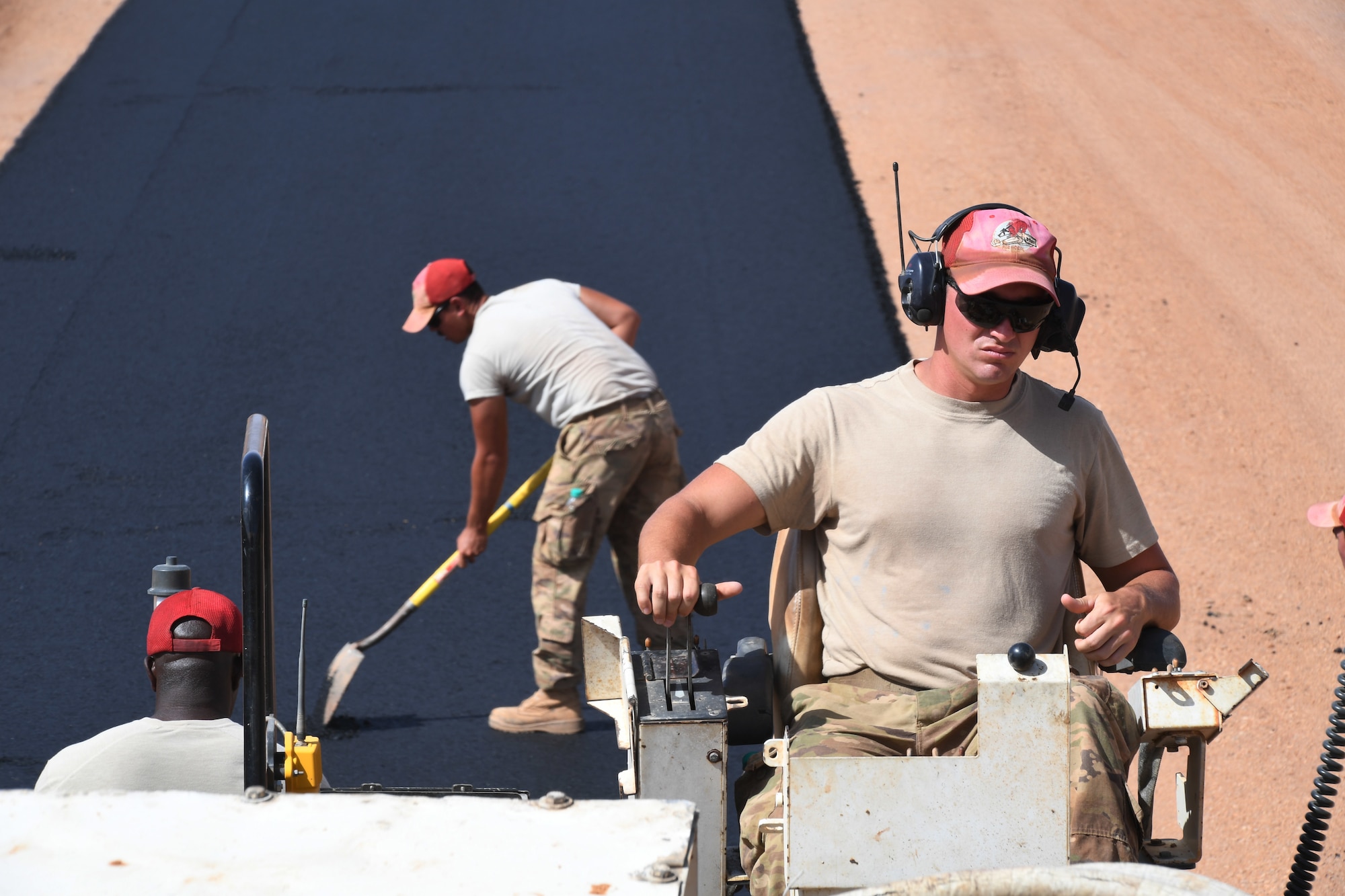 U.S. Air Force Staff Sgt. Channing Henry, 31st Expeditionary Rapid Engineer Deployable Heavy Operation Repair Squadron Engineer pavement and equipment journeyman, operates an asphalt paver on a test strip at Nigerien Air Base 201, Niger, Oct. 19, 2018. Airmen evaluate the equipment and materials several times before laying down the actual runway. (U.S. Air Force photo by Tech. Sgt. Rachelle Coleman)