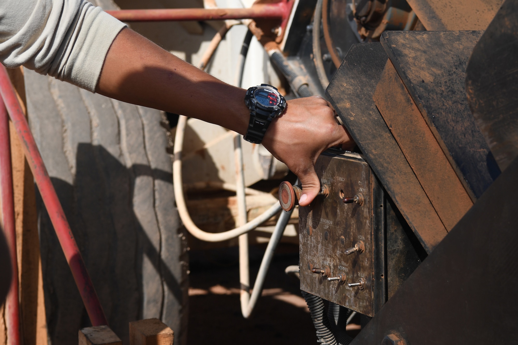 U.S. Air Force Tech. Sgt. Alonzo Marquez, 31st Expeditionary Rapid Engineer Deployable Heavy Operation Repair Squadron Engineer Pavement and equipment, operates Material Transfer Vehicle hopper, mixing asphalt to help continuous paving operations at Nigerien Air Base 201, Niger, Oct. 19, 2018. The MTV allows Airmen to pave continuously with well-mixed asphalt. (U.S. Air Force photo by Tech. Sgt. Rachelle Coleman)