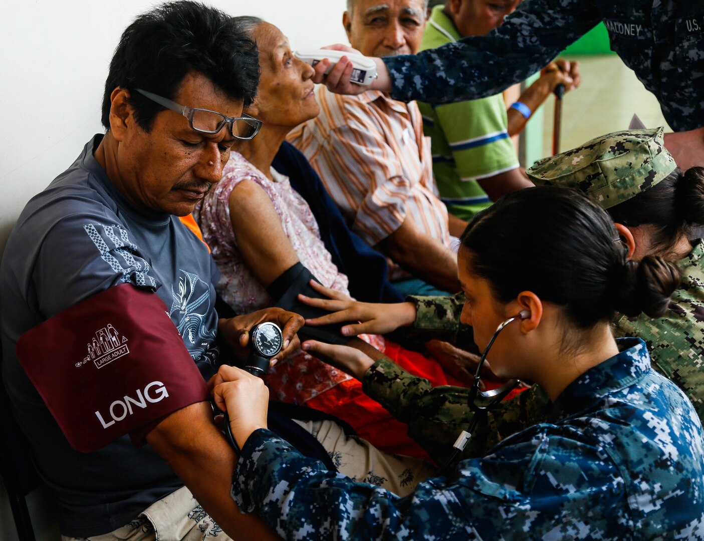 A U.S. Navy Hospitalman checks the blood pressure of a patient in Ecuador.
