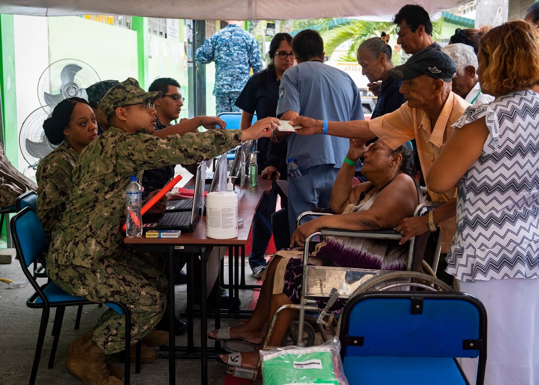 Sailors and partner-nation personnel check in patients at one of two medical sites in Ecuador.