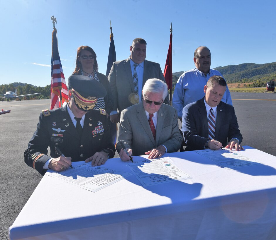 (Front Row, Left to Right) Lt. Col. Cullen Jones, Nashville District commander; U.S. Rep. Hal Rogers, representing Kentucky’s 5th Congressional District, and Dan Mosley, Harlan County Judge Executive, sign a partnership agreement at Tucker Guthrie Memorial Airport Oct. 18, 2018 to formally announce the extension of sewer services to 50 residences and 20 commercial structures along Airport Road. (USACE photo by Lee Roberts)