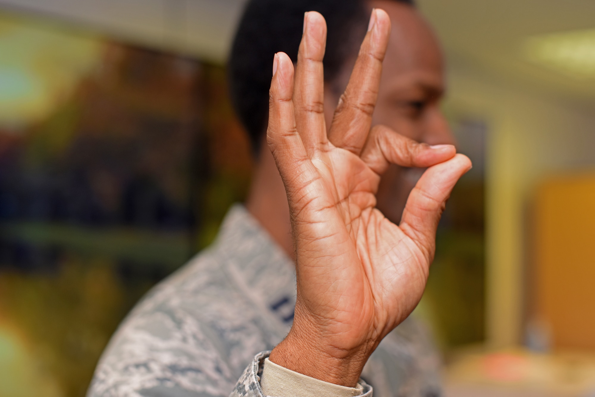 U.S. Air Force Chaplain Capt. Kennie Neal, 100th Air Refueling Wing chaplain, presents the American Sign Language gesture that represents the number nine during an ASL workshop at RAF Mildenhall, England, Oct. 23, 2018. The workshop, which is free and open to all Airmen and their families, is part of a ‘Workplace Etiquettes” action plan developed by the Airman and Family Readiness Center. (U.S. Air Force photo by Airman 1st Class Brandon Esau)