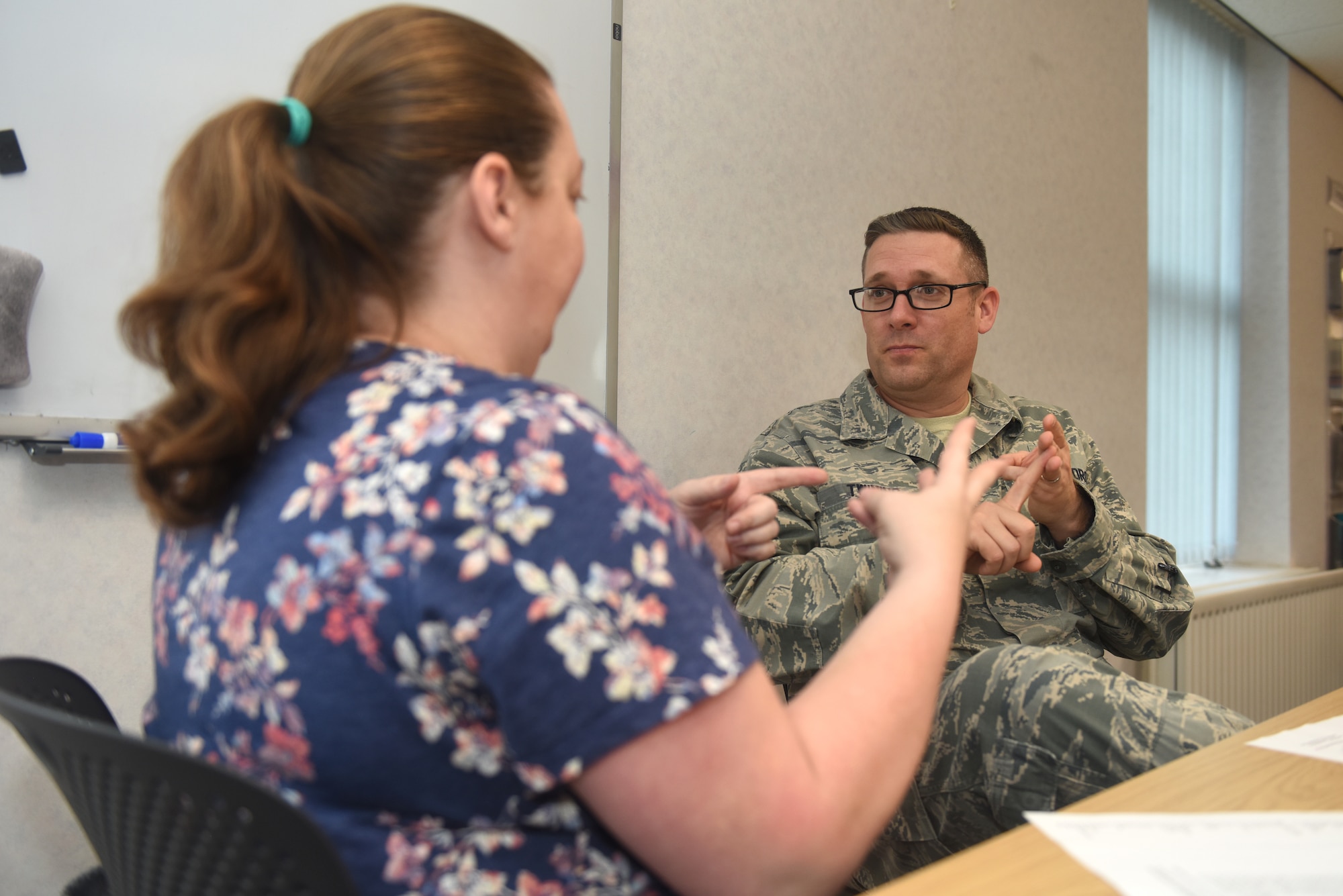 Starlette Twinning and her husband, U.S. Air Force Master Sgt. Ronald Twining, 48th Component Maintenance Squadron propulsion flight superintendent, RAF Lakenheath, England, practice American Sign Language during an ASL workshop at RAF Mildenhall, England, Oct. 23, 2018. The workshop, which was free and open to all Airmen and their families, is part of a ‘Workplace Etiquettes” action plan developed by the Airman and Family Readiness Center. (U.S. Air Force photo by Airman 1st Class Brandon Esau)