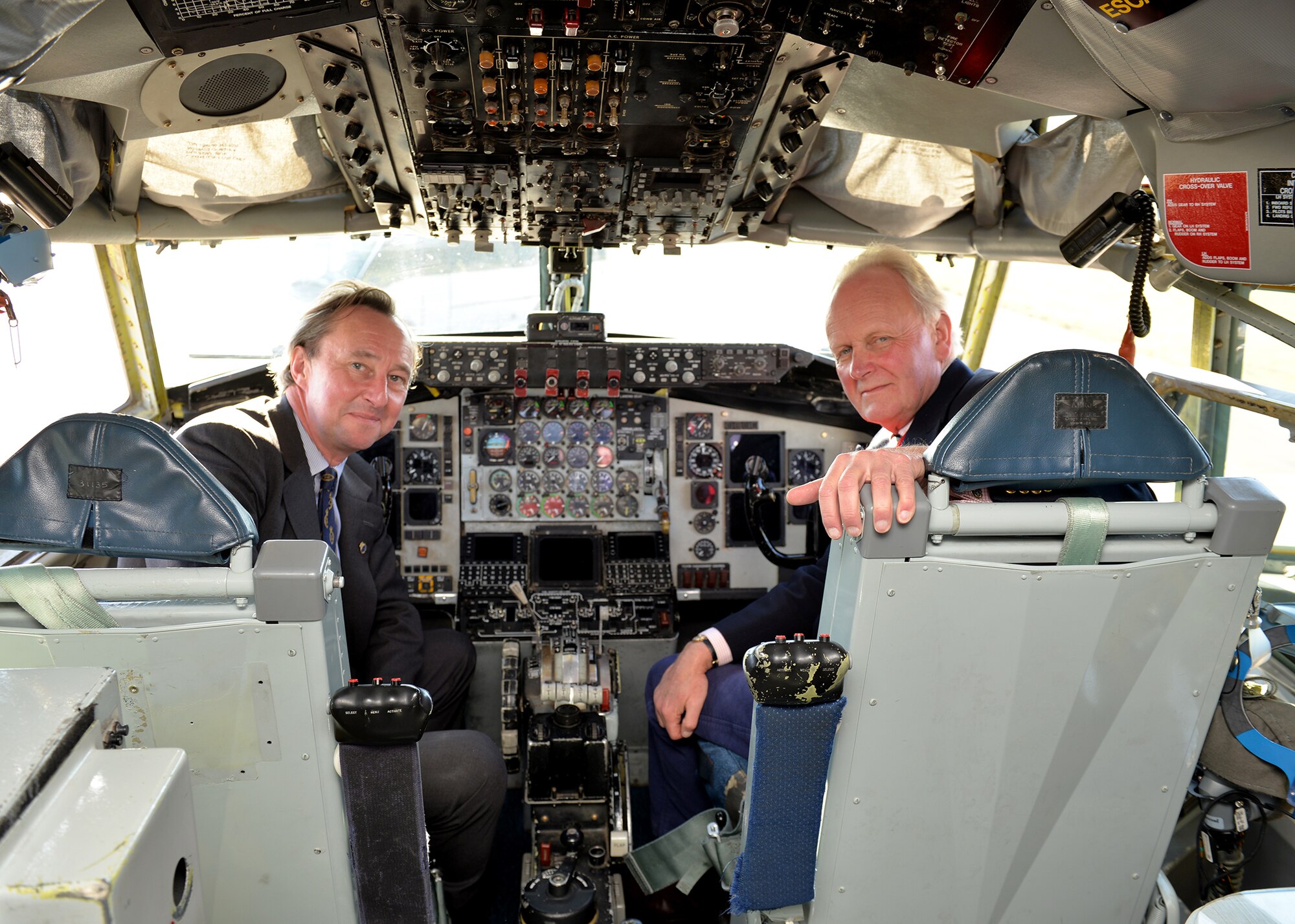 George Vestey, High Sheriff of Suffolk, and Charles Watt, High Sheriff of Norfolk, pose for a photo in a KC-135 Stratotanker during base tour of RAF Mildenhall, England, Oct. 19, 2018. The community leaders were given the opportunity to speak to Airmen and learn about their career fields. (U.S. Air Force photo by Karen Abeyasekere)