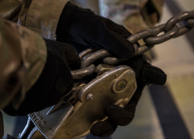 A U.S. Army Soldier locks a chain during a training exercise at Joint Base Langley-Eustis, Virginia, Oct. 18, 2018.