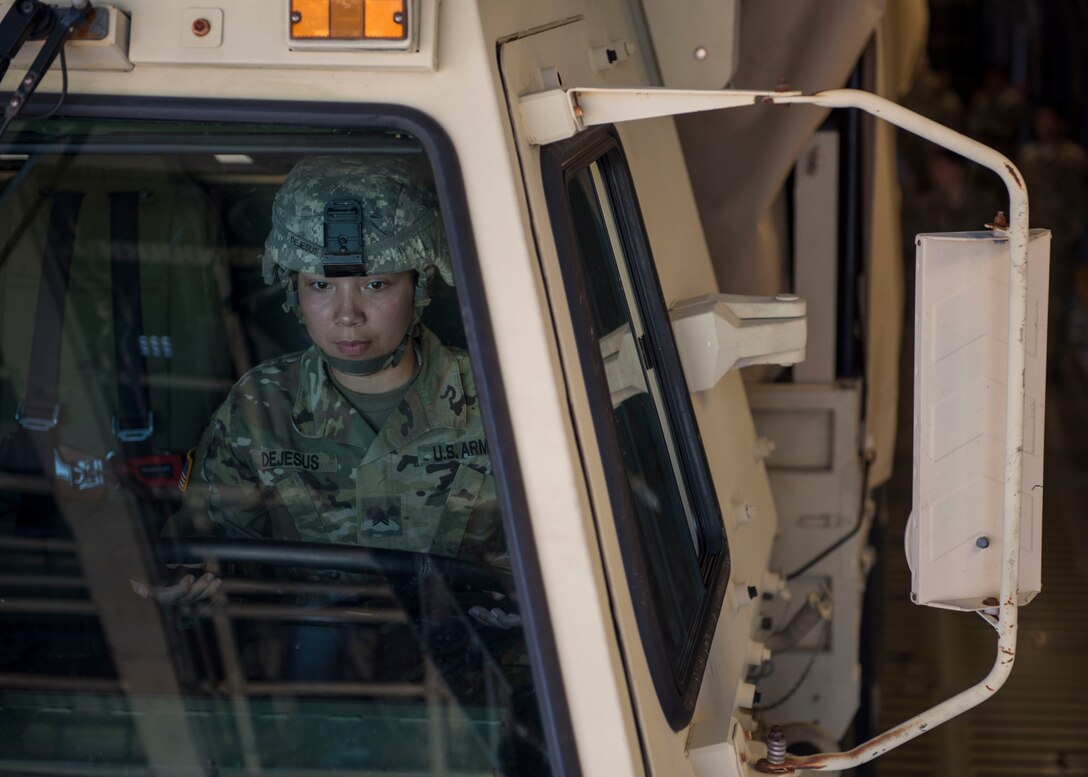 U.S. Army Sgt. Amanda Dejesus, 11th Transportation Battalion, Headquarters and Headquarters Detachment, 7th Transportation Brigade (Expeditionary) motor transport operator, loads a cargo truck onto a U.S. Air Force C-5M Super Galaxy during a training exercise at Joint Base Langley-Eustis, Virginia, Oct. 19, 2018.