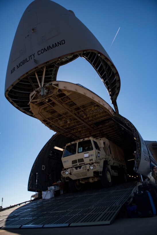 A U.S. Army Soldier drives a cargo truck off a U.S. Air Force C-5M Super Galaxy during a training exercise at Joint Base Langley-Eustis, Virginia, Oct. 19, 2018.