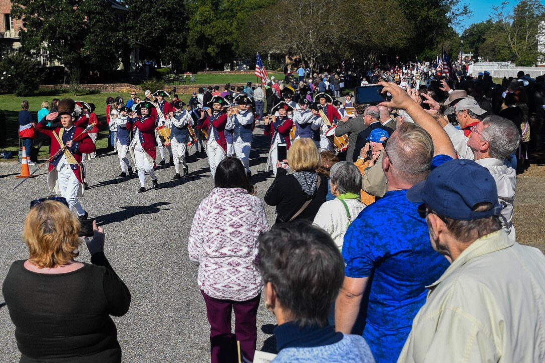 Attendees cheer, photograph and record as participants march by during the Yorktown Day parade at Colonial National Historic Park in Yorktown, Virginia, Oct. 19, 2018.