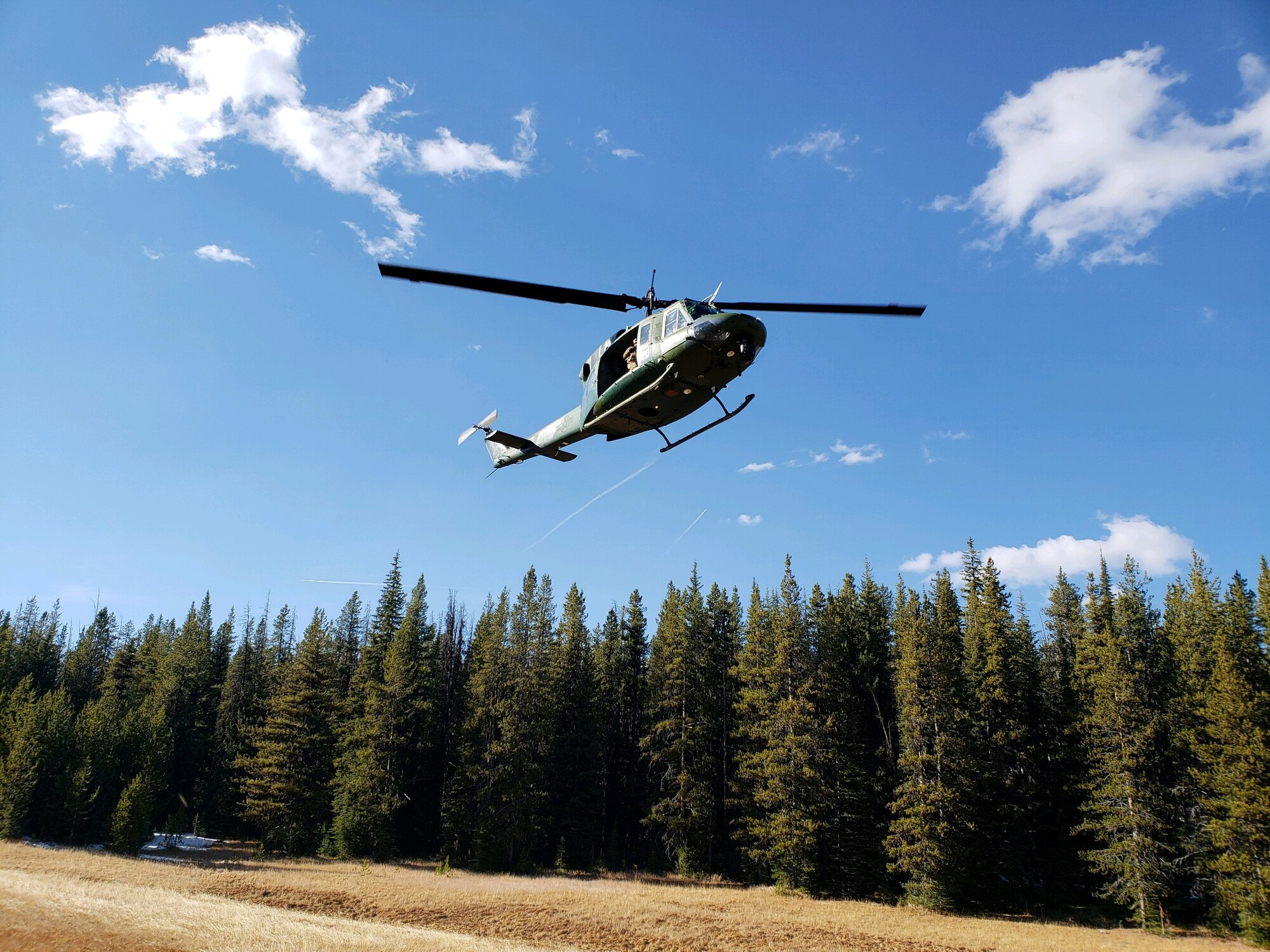 A UH-1N helicopter prepares to land on a mountain Oct. 22, 2018, at Ravalli County, Mont.