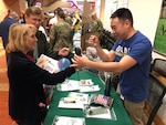 A Brooke Army Medical Center staff member tests the grip strength of an attendee during the Joint Base San Antonio and Brooke Army Medical Center Military Retiree Appreciation Day Oct. 20 in the hospital’s Medical Mall.