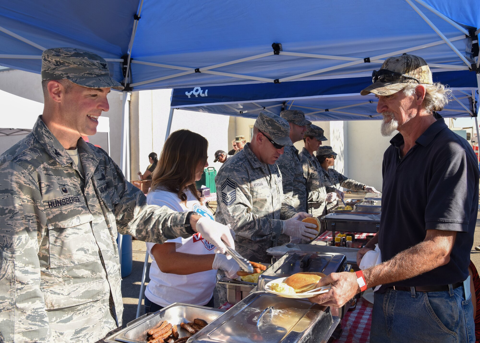 Col. Michael Hunsberger, 30th Mission Support Group commander, serves breakfast to a local veteran at the Veteran Stand Down event, Oct. 20, 2018 at Santa Maria Fair Grounds, Calif. There were two free meals for all who came to the Stand Down event, as well as free clothing, supplies and services provided.