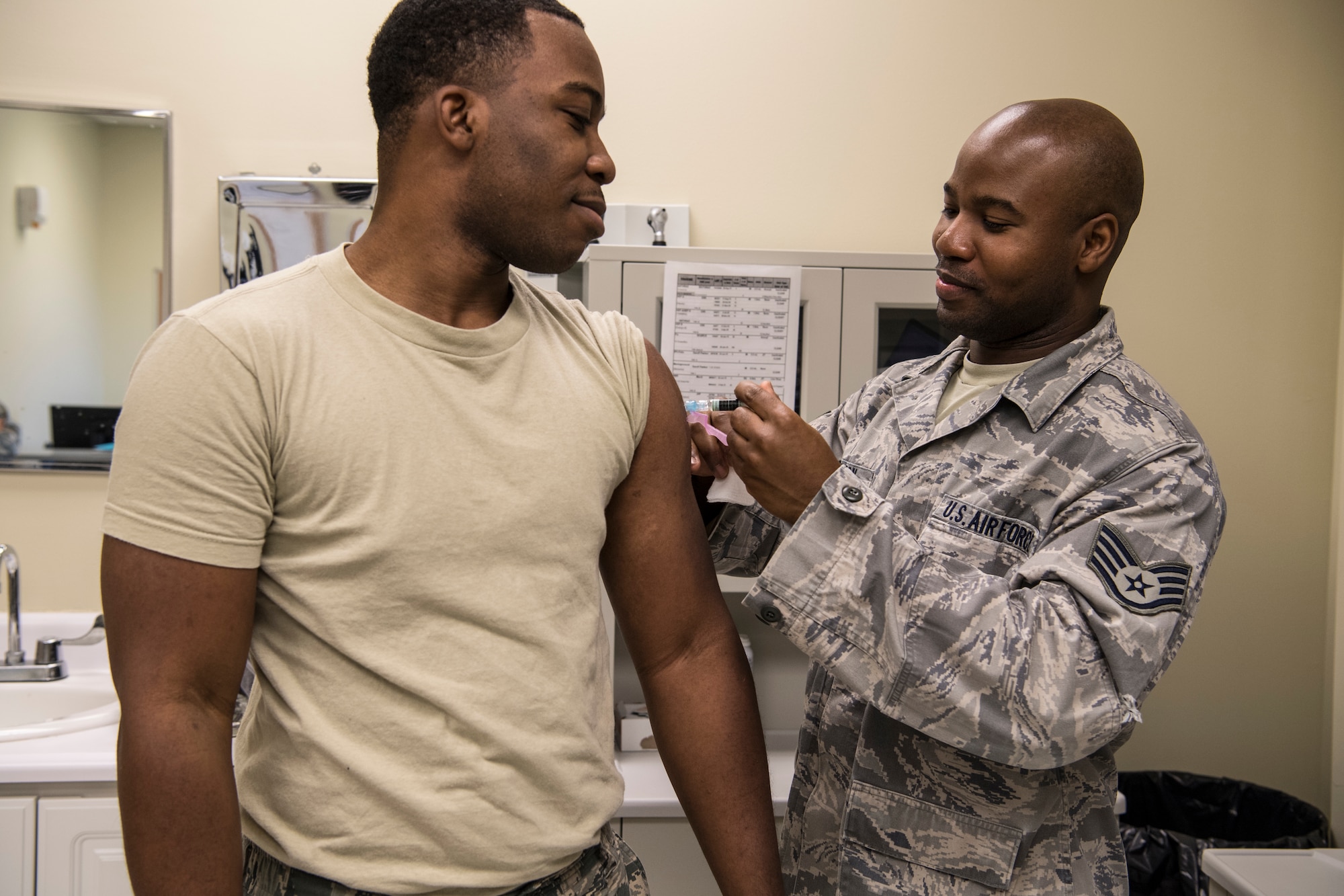 Airman 1st Cass Jonah Douglas, 434th Aerospace Medicine Squadron health services technician, receives an influenza vaccination from Staff Sgt. Lavarous Johnson, 434th AMDS medical technician, at Grissom Air Reserve Base, Ind., Oct. 23, 2018. Grissom is required to achieve a vaccination rate of 90% or higher before the end of the year. (U.S. Air Force photo / Senior Airman Harrison Withrow)