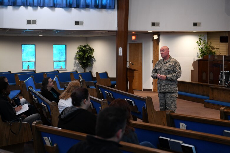 photo of Airmen and teacher