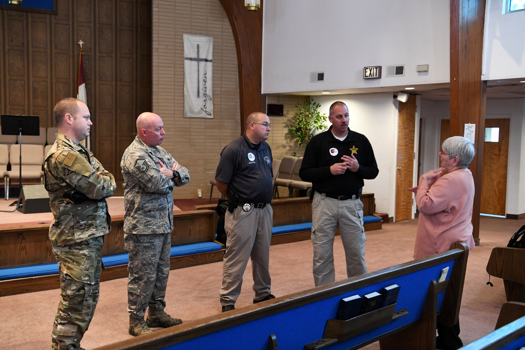 photo of Airmen and teacher