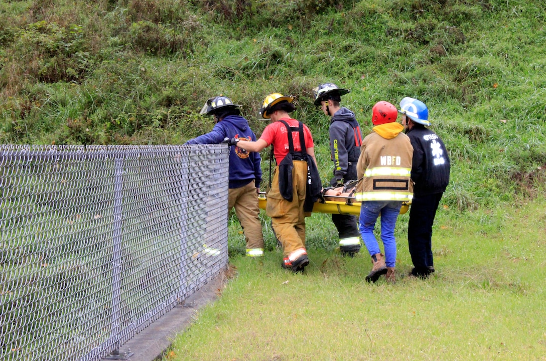 Team members from Wells Bridge, Otego and Unadilla fire departments practice rescue operations with a training mannequin in support of the U.S. Army Corps of Engineers, Baltimore District, during a training simulation held at East Sidney Lake Dam in Delaware County, New York, Oct. 13, 2018. (U.S. Army photo by Brianna K. Dandridge)