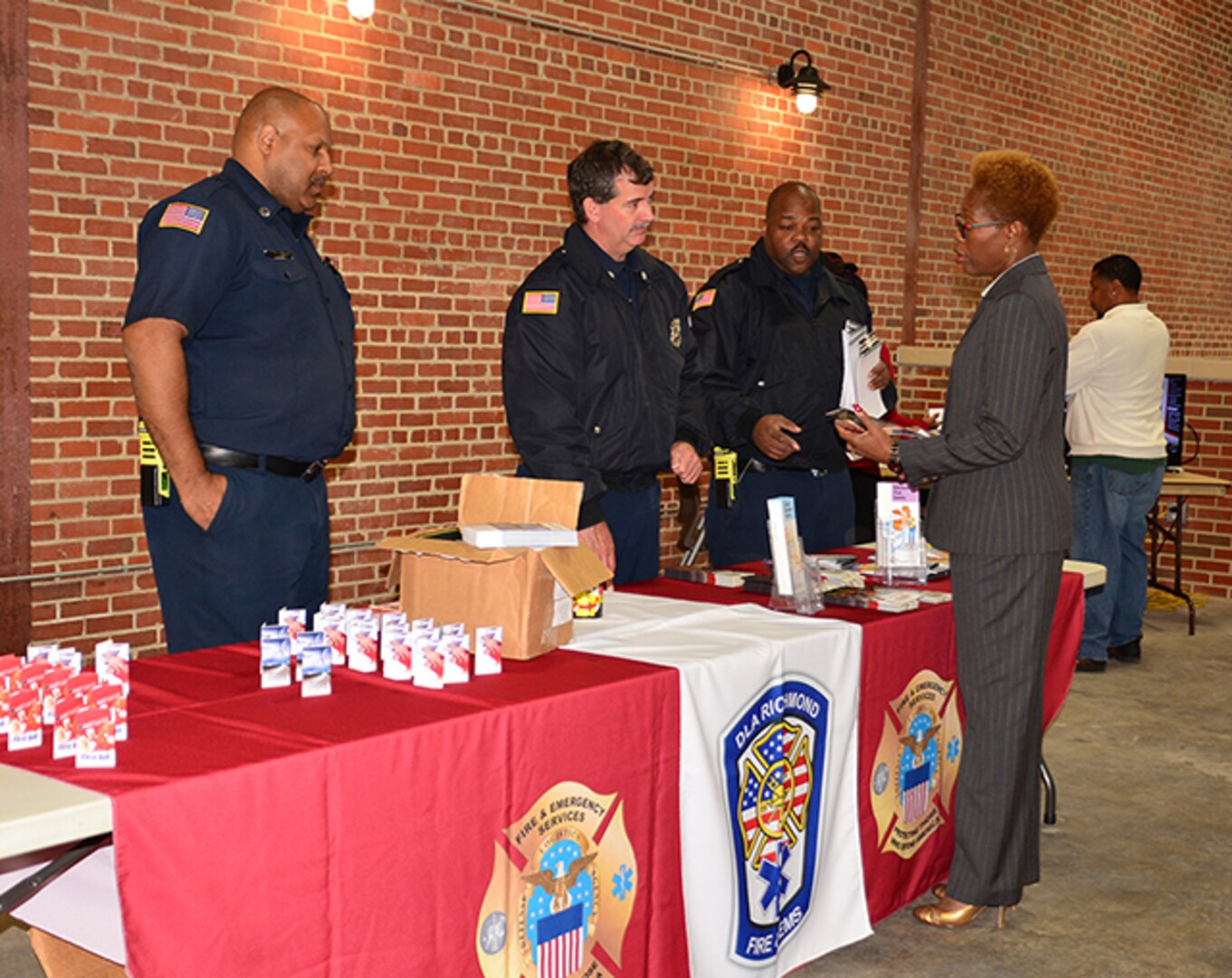 Firefighters speak with employees at Safety Stand Down