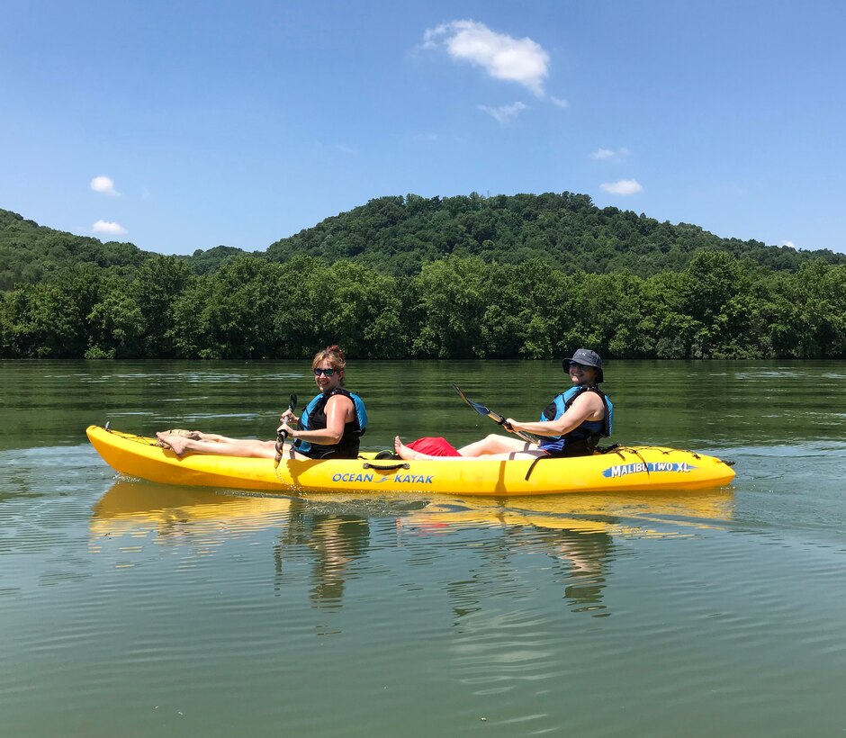 Sarah Wiles (Right), geologist with the U.S. Army Corps of Engineers Nashville District, and Karen Halter, accountant in the Resource Management Division, kayak on the Cumberland River in Gainesboro, Tenn., June 16, 2018 on Leg 24 of a 650.4-mile journey of the Cumberland River. The objective of navigating the waterway was to celebrate the 130th Anniversary of the U.S. Army Corps of Engineers Nashville District, reflect on the development of the Cumberland River Basin, remember the past, enjoy the present, and dream about the future of the waterway that is vitally important to the region. (USACE Photo)