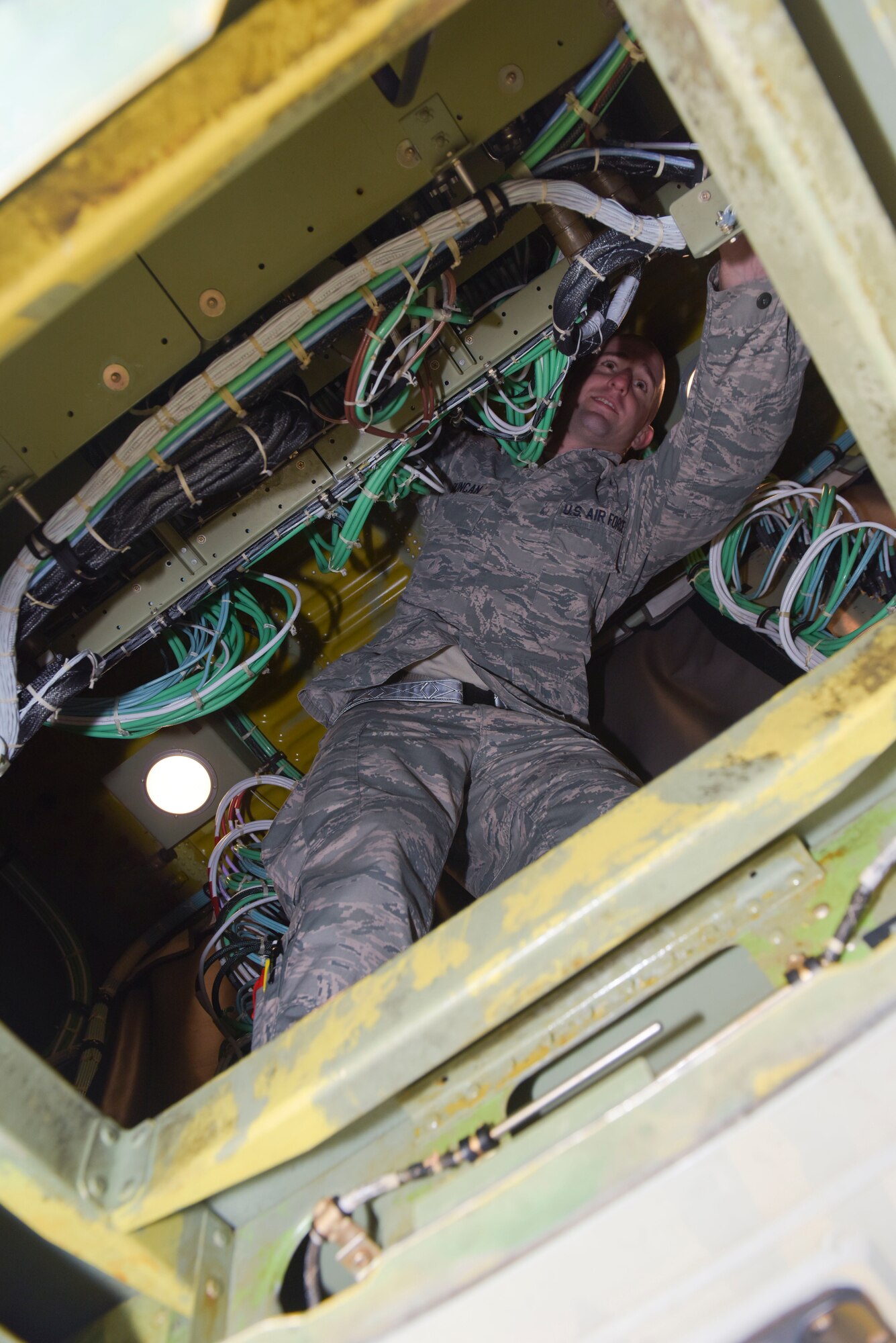 U.S. Air Force Staff Sgt. Randy Duncan, 95th Reconnaissance Squadron RC-135 electronic warfare craftsman, repairs the power distribution for a RC-135 Rivet Joint connection system at RAF Mildenhall, England, Oct. 16, 2018.