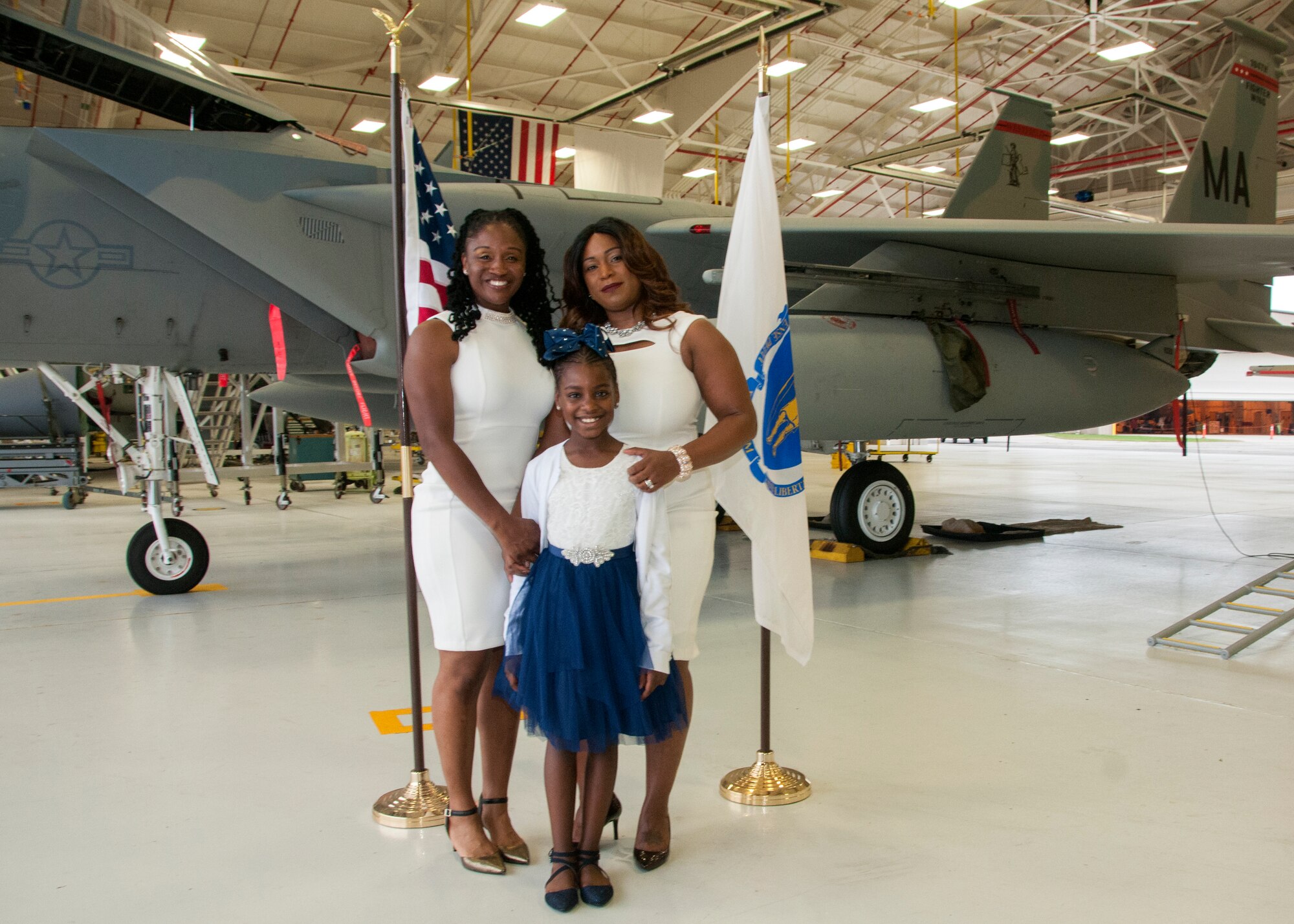 Tysha M. Wiggins, Chimia Coleman and London Lindo pose for a picture after Wiggins enlisted into the 104th Maintenance Group as a crew chief Oct. 11, 2018, at Barnes Air National Guard Base, Massachusetts. Wiggins and her family chose to join the 104th Fighter Wing because of the family orientated environment. (U.S. Air National Guard Photo by Airman 1st Class Randy Burlingame)