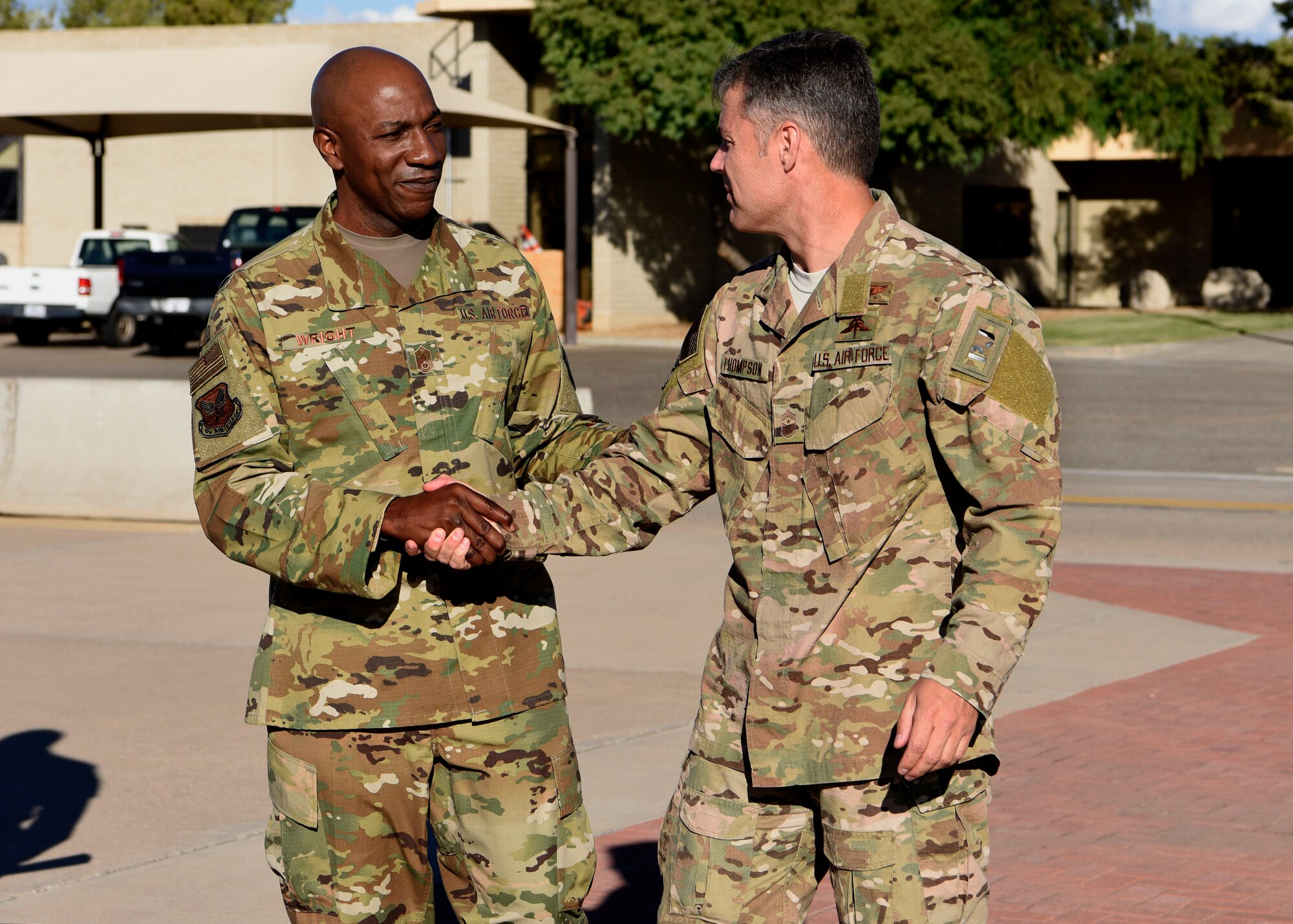 Chief Master Sgt. of the Air Force Kaleth O. Wright shakes hands with Chief Master Sgt. Ronald Thompson, 56th Fighter Wing command chief during a base tour Oct. 22, 2018 at Luke Air Force Base, Ariz.