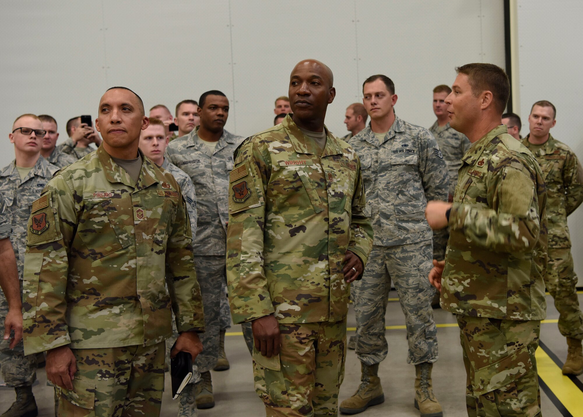 U.S. Air Force First Sergeant Chief Master Sgt. Manuel Piñeiro and Chief Master Sgt. of the Air Force Kaleth O. Wright speak with Senior Master Sgt. Talmadge Harrison, 62nd Aircraft Maintenance Unit assistant superintendent, during a base tour Oct. 22, 2018 at Luke Air Force Base, Ariz.