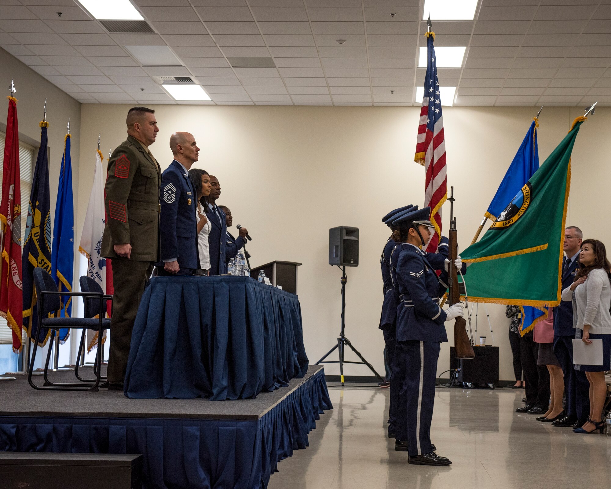 Congressional Military Family Summit keynote speakers stand for the national anthem at Fairchild Air Force Base, Washington, Oct. 17, 2018. The program gave leaders and advocates from numerous military and civilian organizations the opportunity to speak with and address active duty, guard, reserve and retired members’ concerns regarding military and family life. (U.S. Air Force photo/Airman 1st Class Whitney Laine)