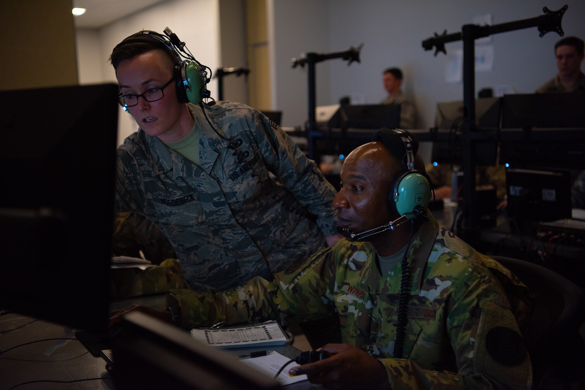 Staff Sgt. Amber Hoedebeck, 607th Air Control Squadron weapons director, guides Chief Master Sgt. of the Air Force Kaleth O. Wright as he conducts an in a flight simulation at the 607th ACS, Oct. 22, 2018 at Luke Air Force Base, Ariz.