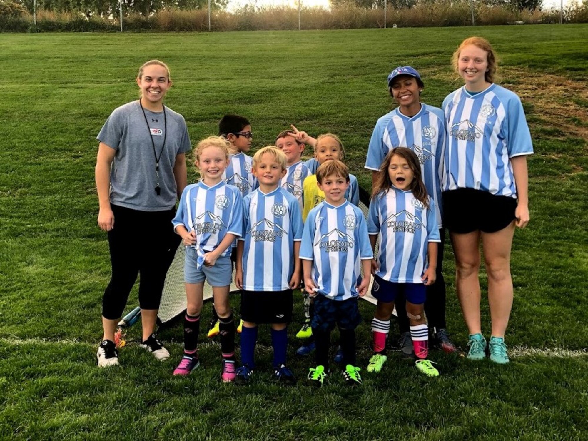 Sara Burton (far right), a junior cadet at the U.S. Air Force Academy, stands with the children and staff on the  Avengers soccer team, sponsored by the Colorado Springs youth sports program. Burton was the team’s head coach until the season ended in October. (Courtesy photo)