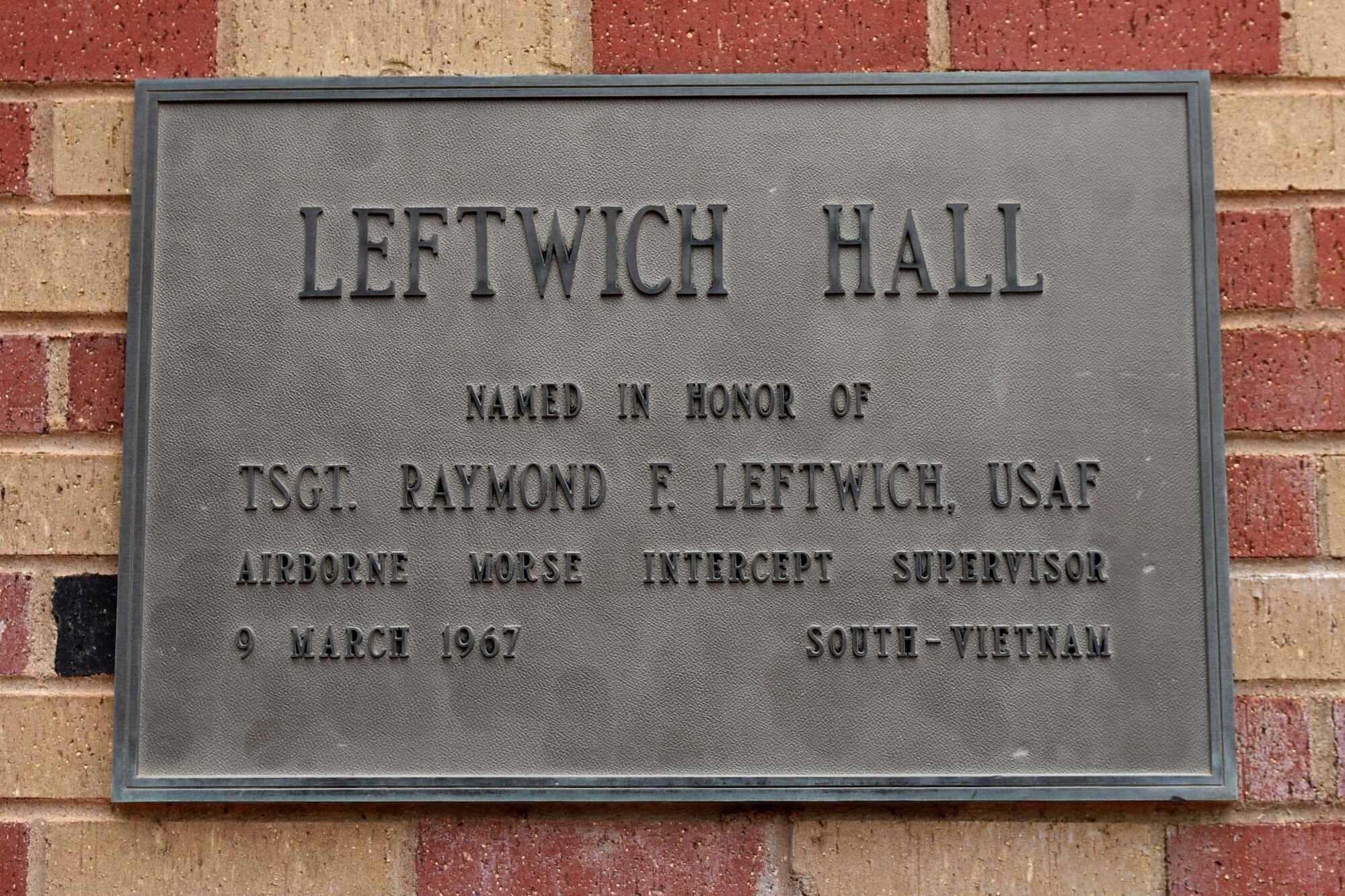 The memorial plaque on Leftwitch Hall at Goodfellow Air Force Base, Texas, Oct. 23, 2018. Goodfellow named building 255 in honor of U.S. Air Force Tech. Sgt. Raymond Leftwich on July 3, 1985. (U.S. Air Force photo by Senior Airman Randall Moose/Released)