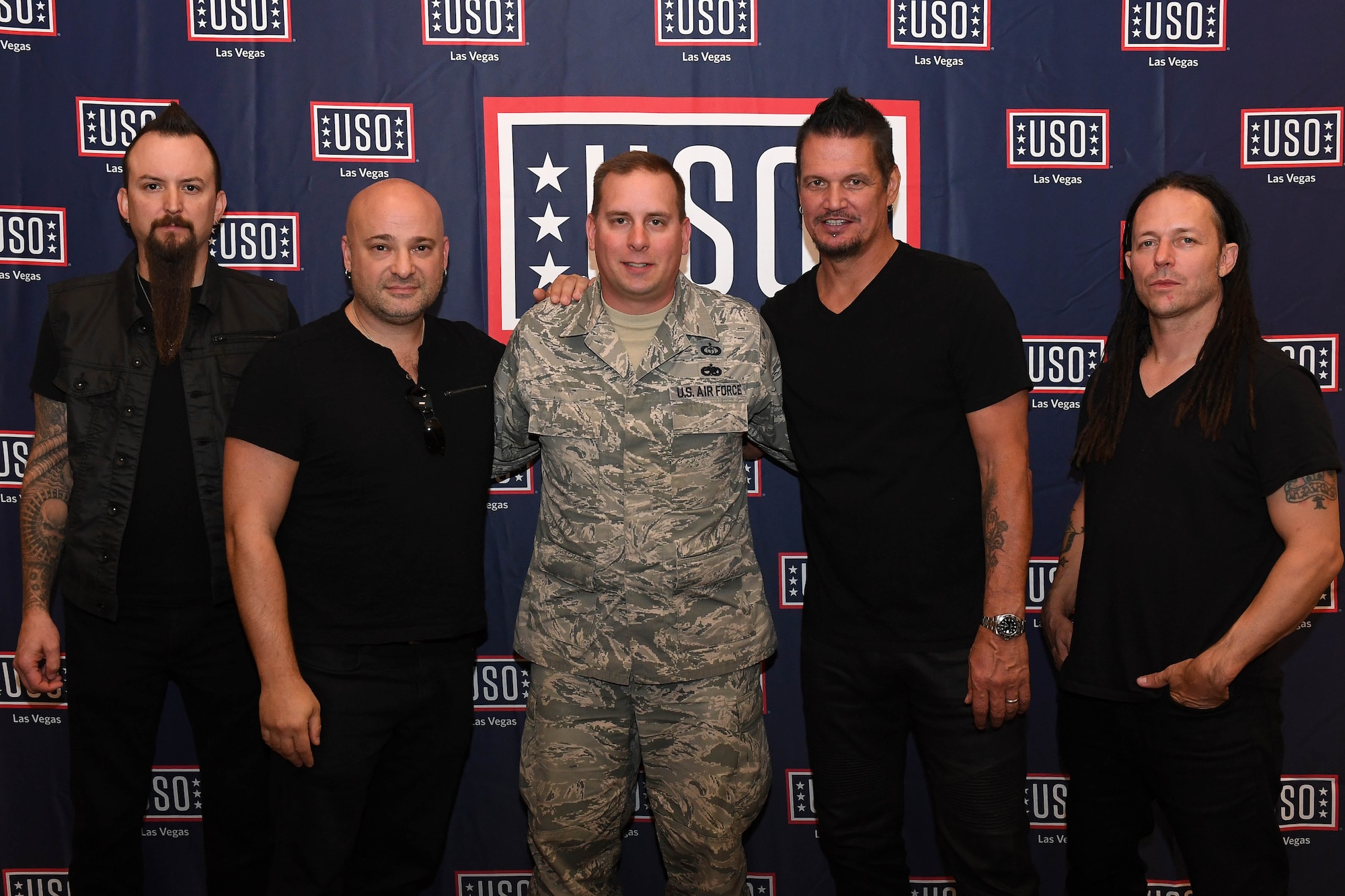 Tech. Sgt. Jason, 30th Reconnaissance Squadron flight chief, takes a photo with Disturbed at Creech Air Force Base, Nevada October. 23, 2018. Disturbed came to Creech via the USO and performed a concert for Airmen after learning about the wing mission. (U.S. Air Force photo by Senior Airman Christian Clausen)